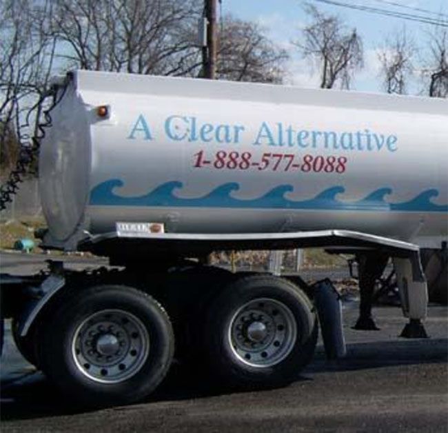 A clear alternative truck is parked on the side of the road