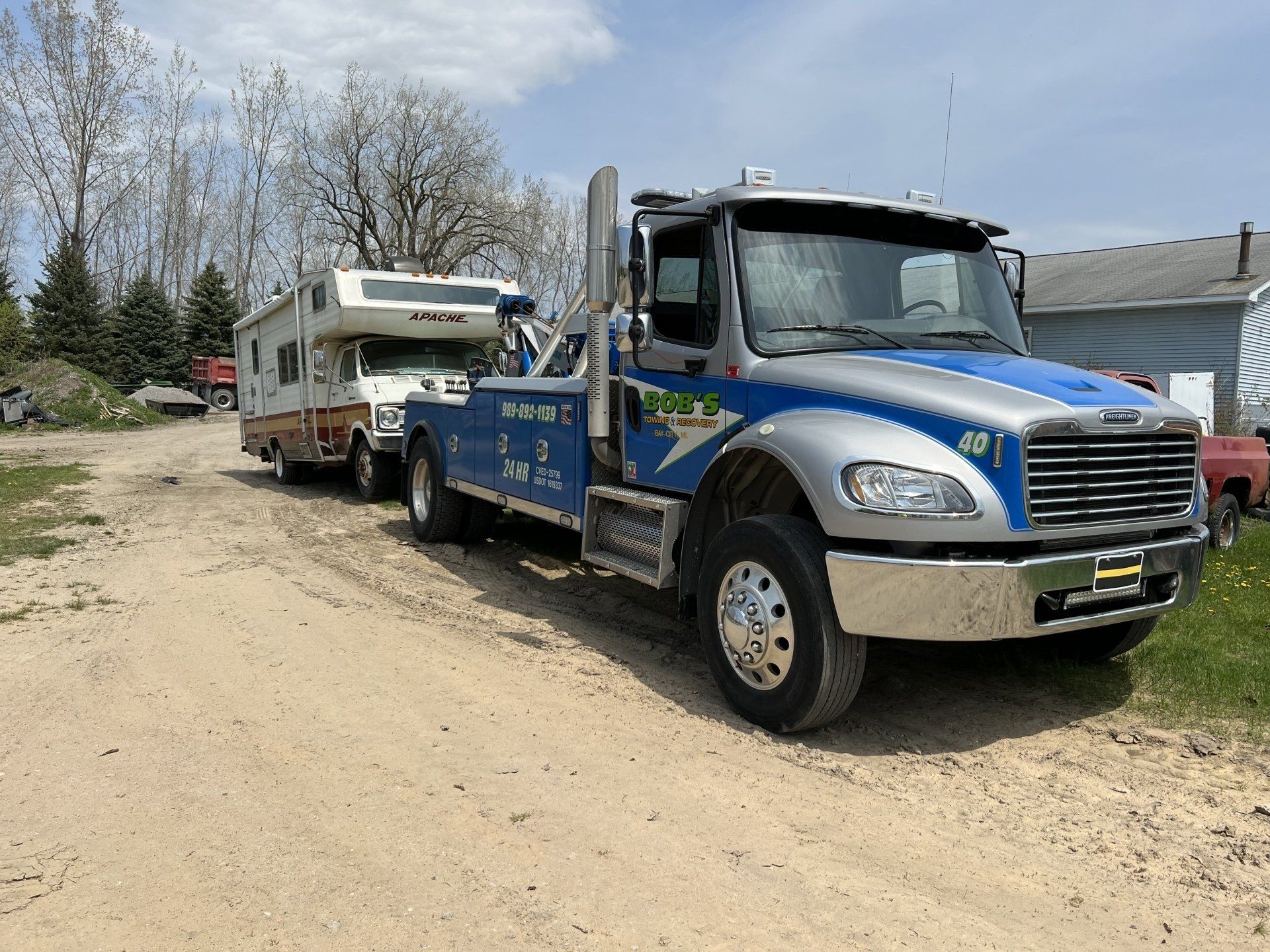 Blue tow truck with an RV