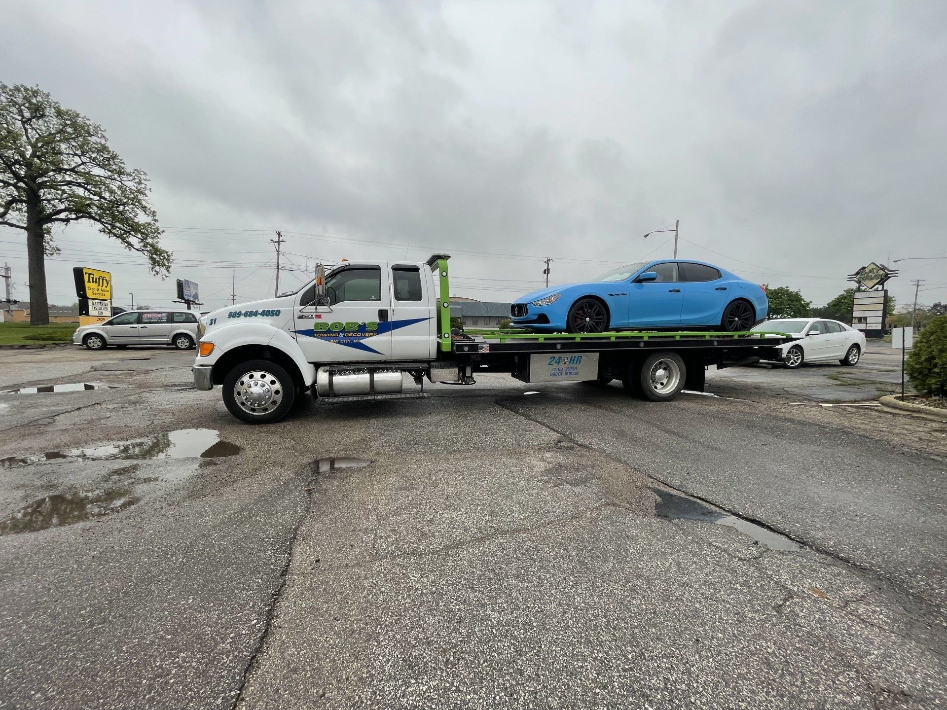 Blue sports car towed