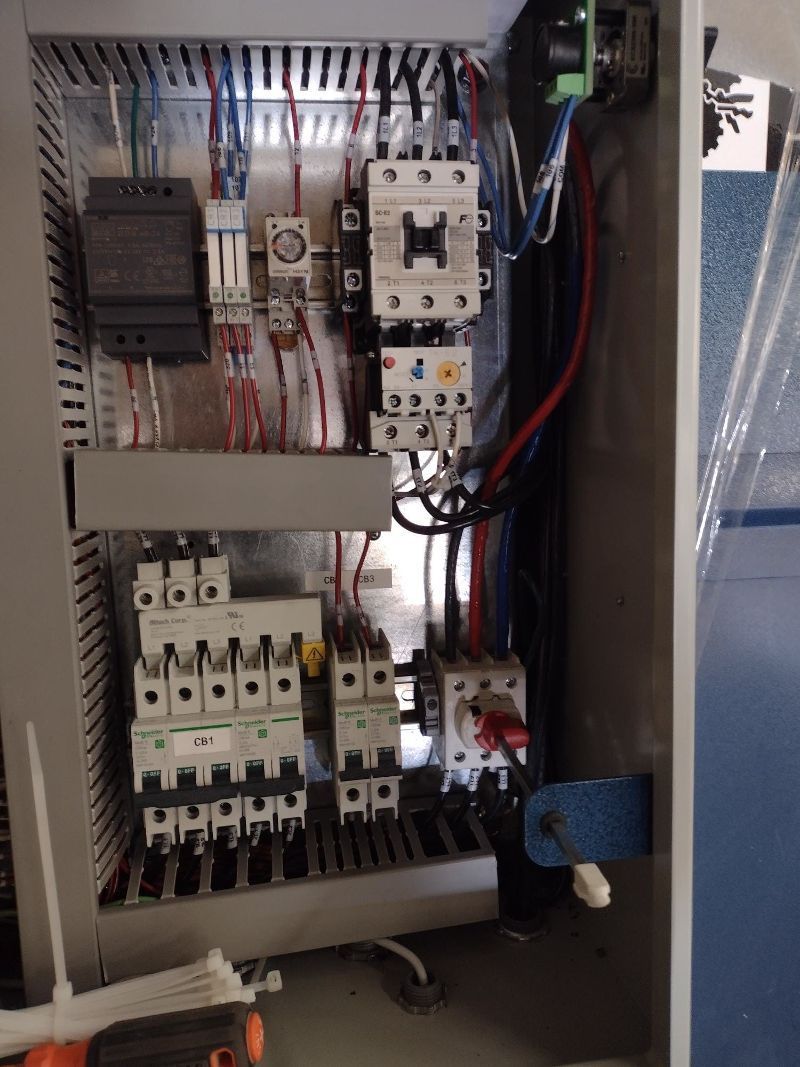 A close up of an electrical panel with a screwdriver in it