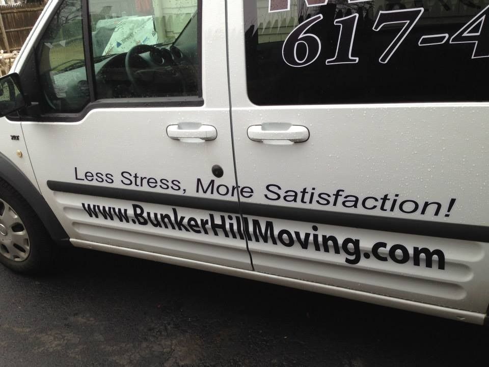 Side view of a white van with the text 