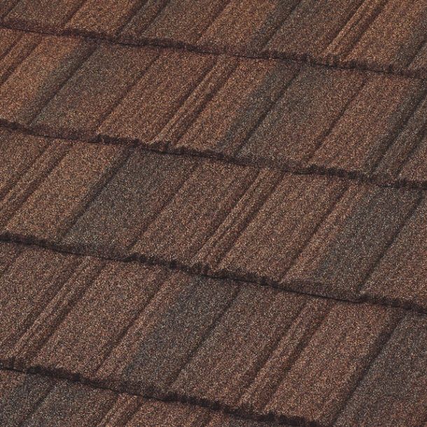 Close-up of overlapping brown metal roof tiles. The tiles have a textured, weathered appearance.