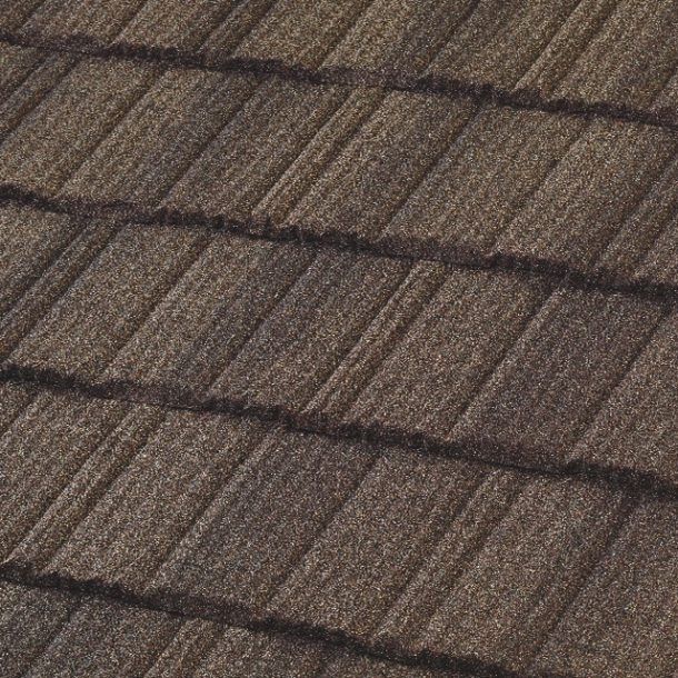 Close-up of a brown, textured roof made of overlapping rectangular tiles.