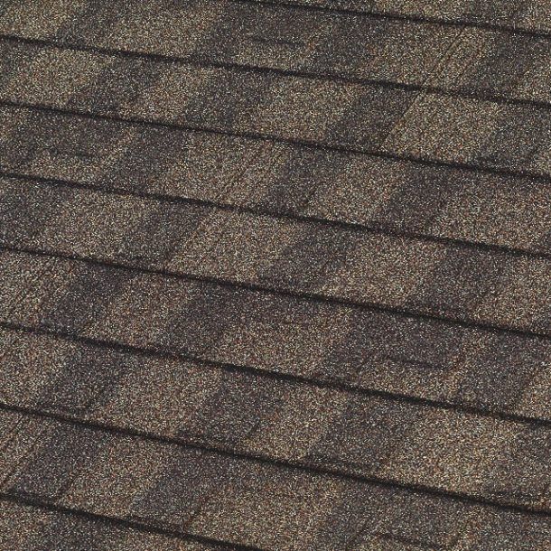 Close-up of a brown asphalt shingle roof with horizontal rows and visible texture.