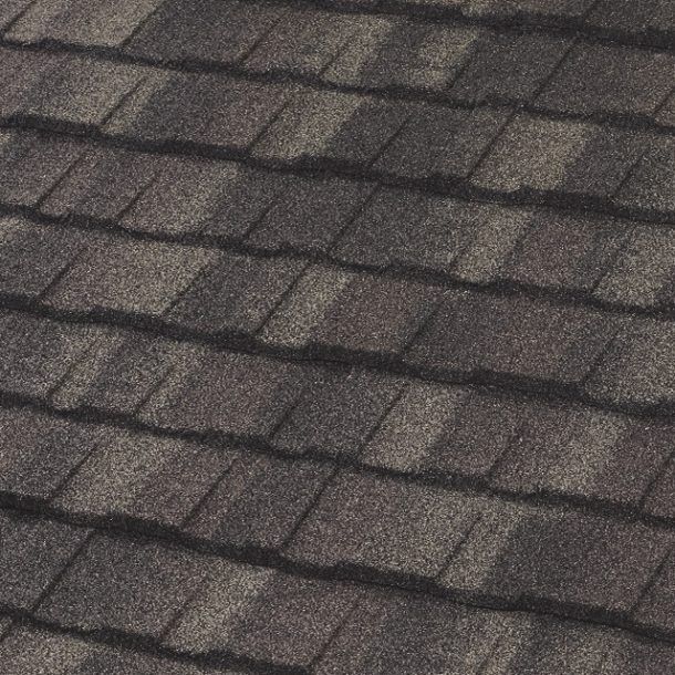 Close-up of a dark brown asphalt shingle roof. The shingles have a granular texture and overlap in rows.