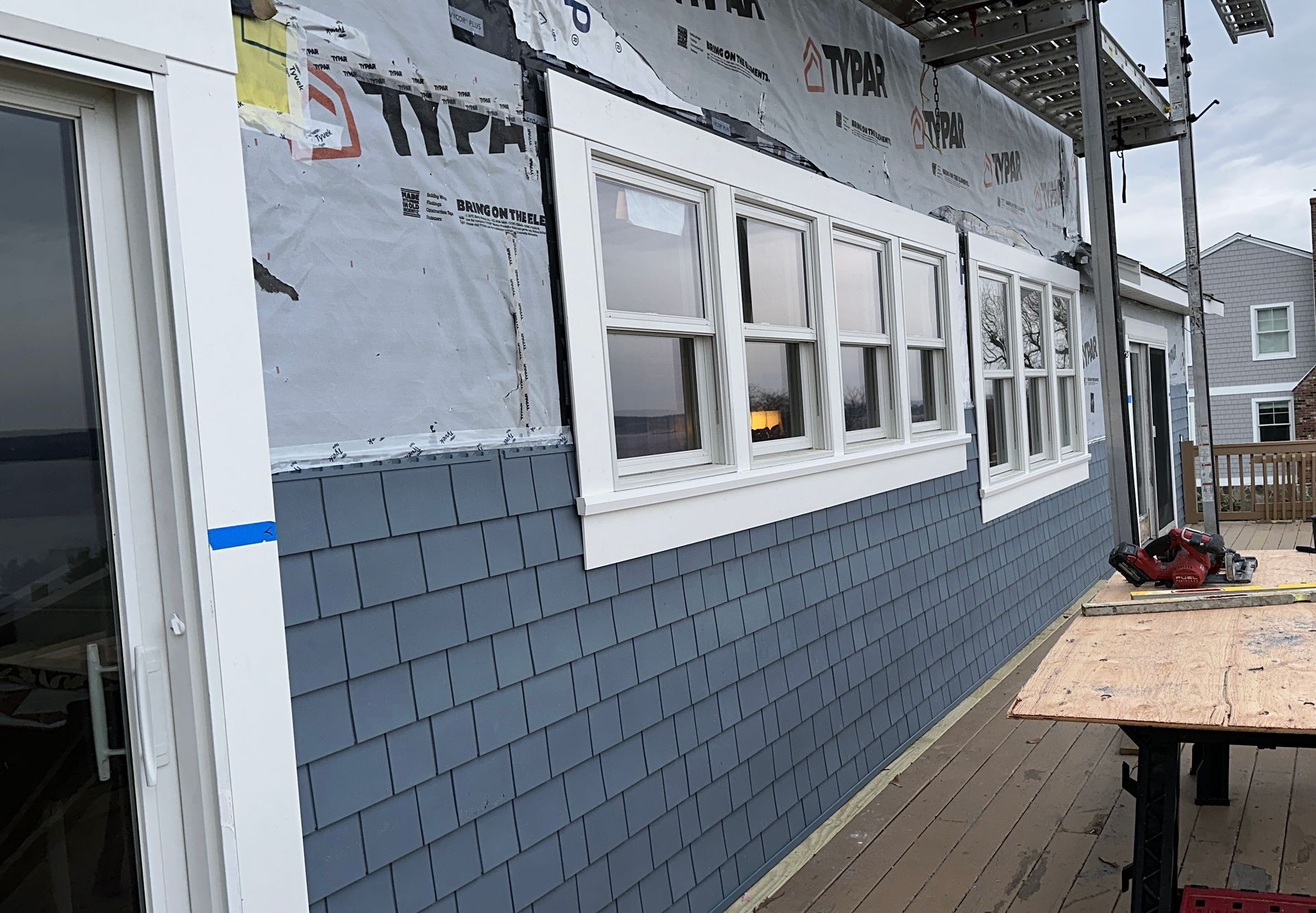 A brick building with a lot of windows is being remodeled.