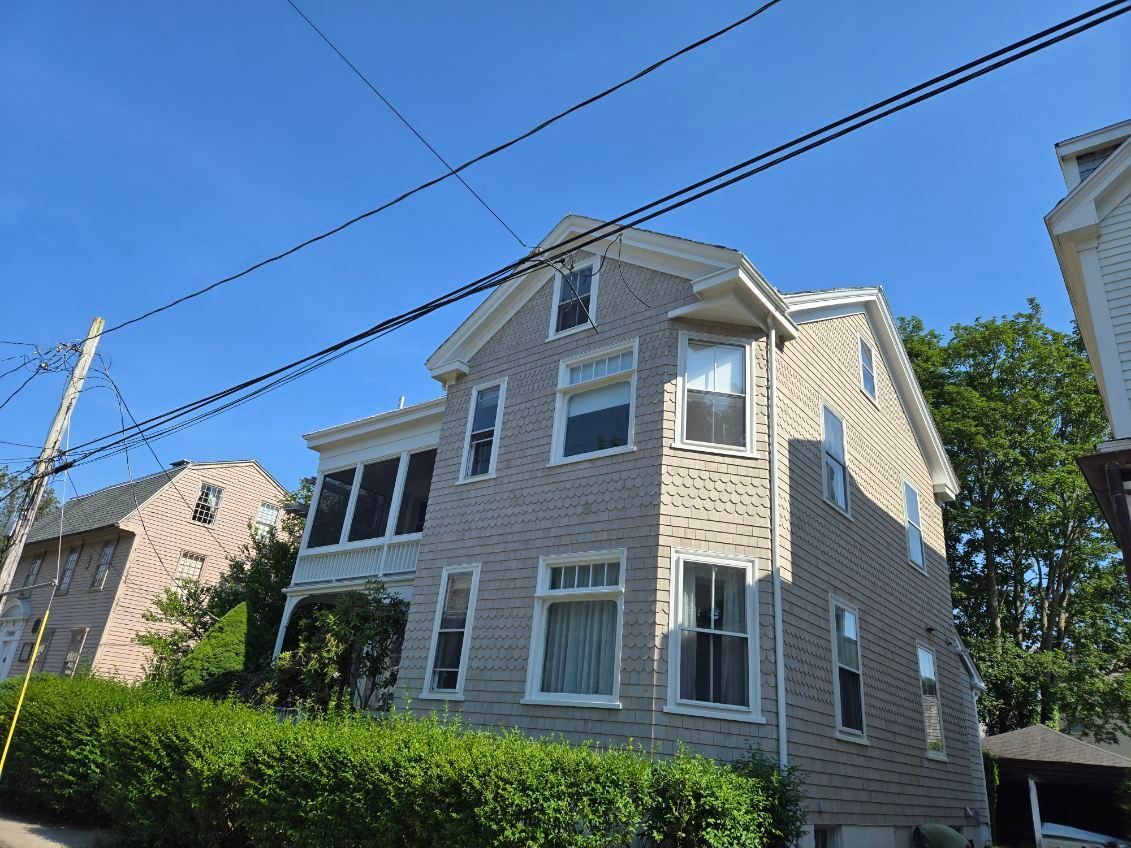 A house with a lot of windows and a blue sky in the background.