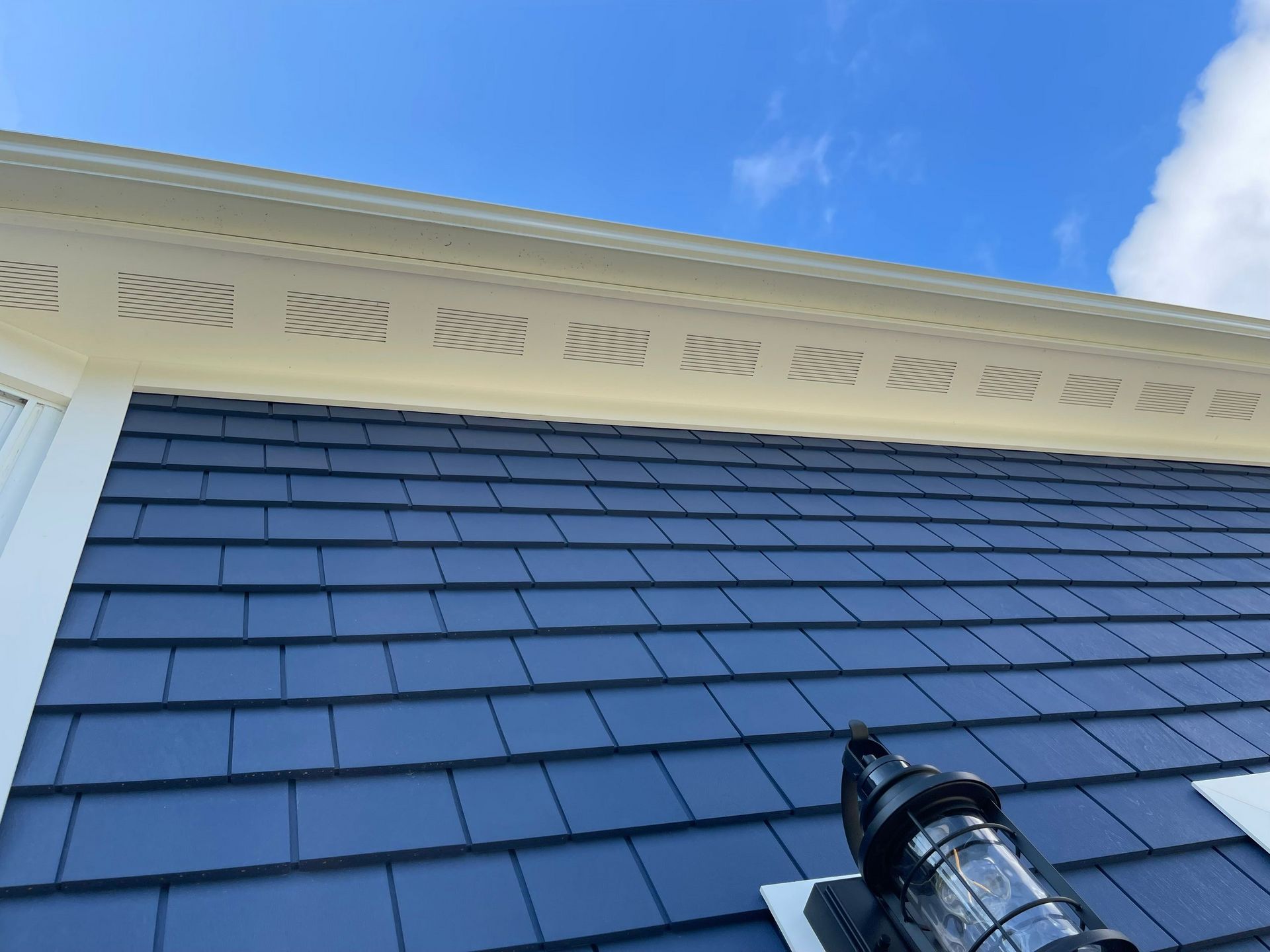 A very tall building with a blue sky in the background.
