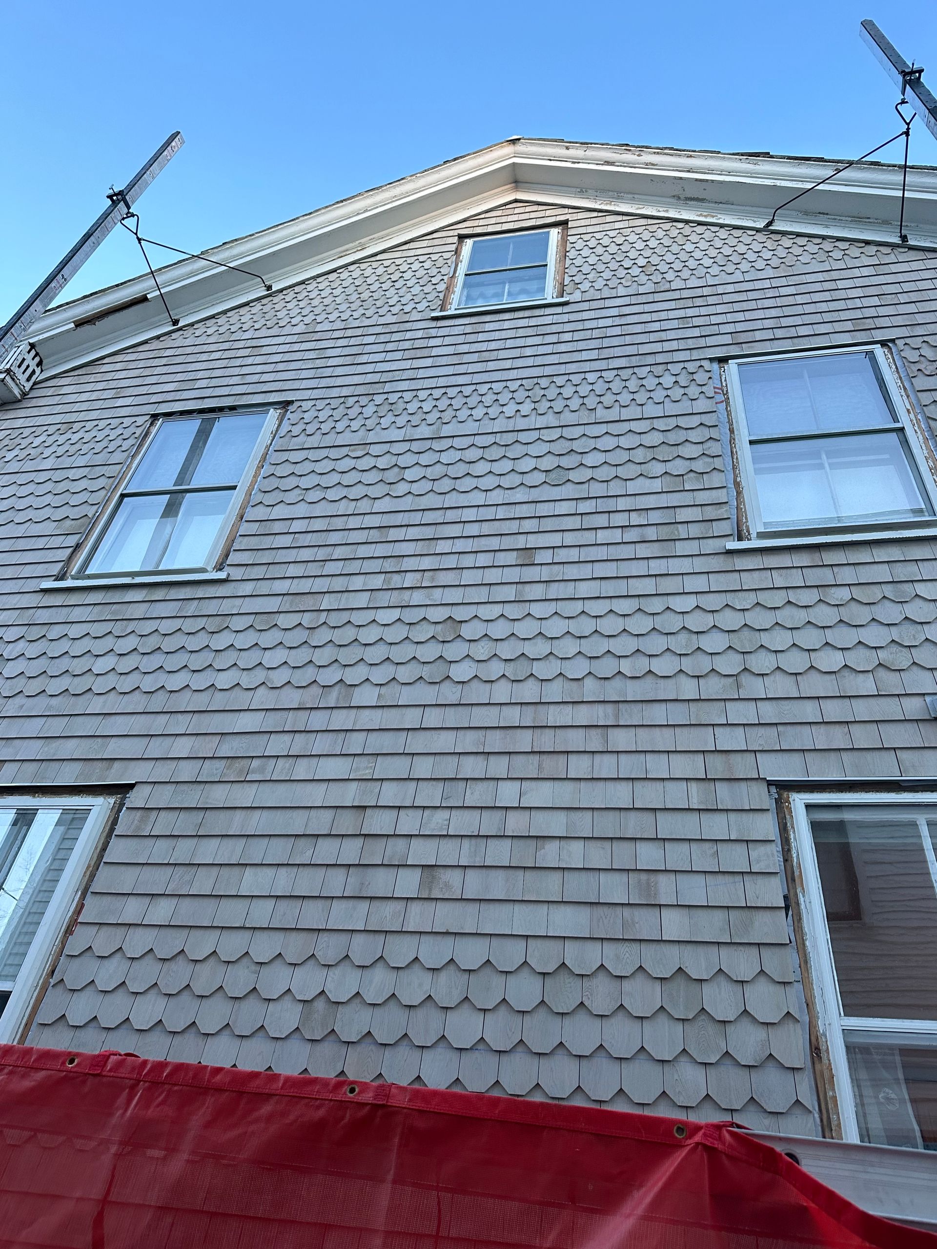 Looking up at a house with a blue sky in the background.