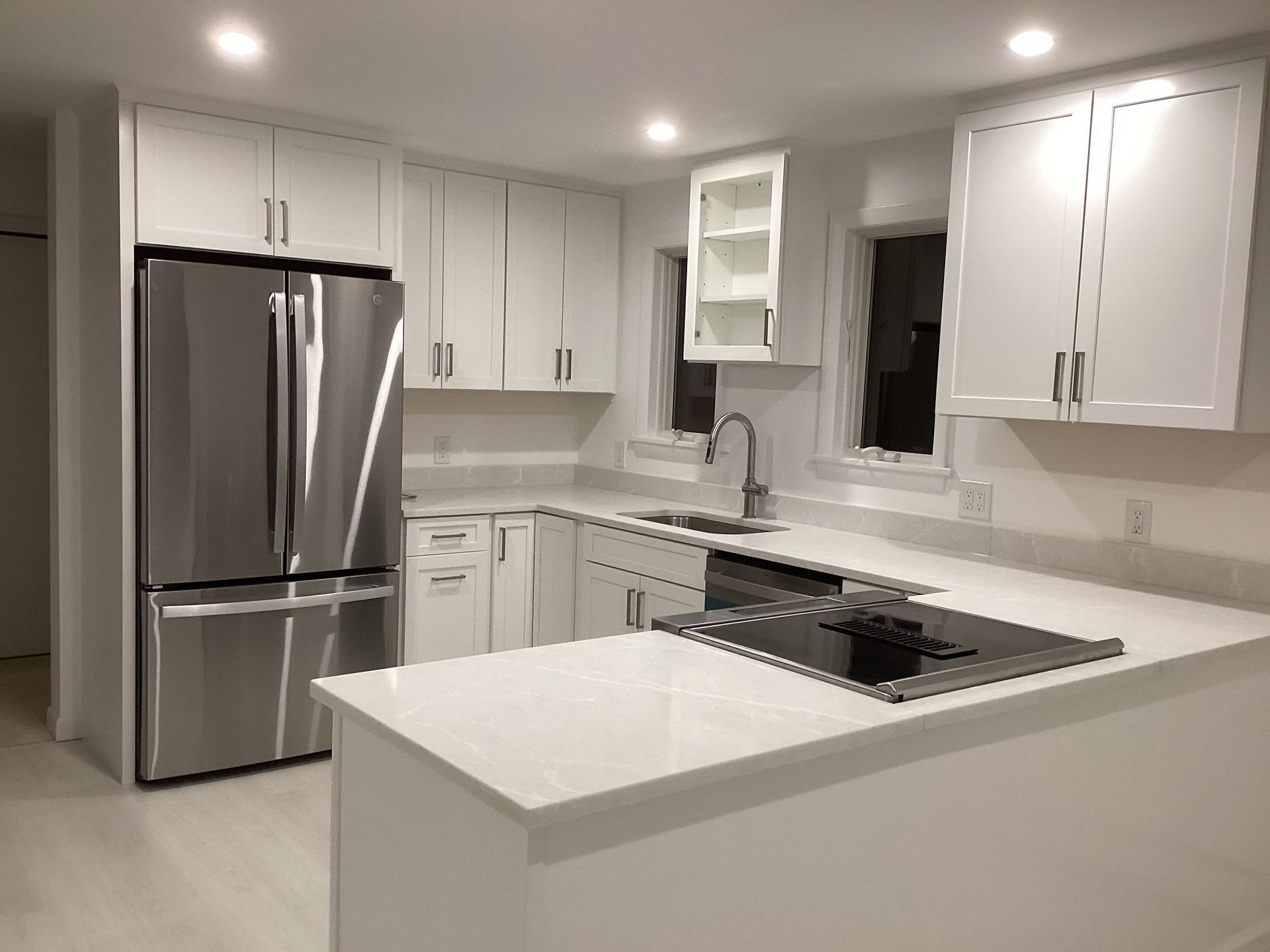 A kitchen with white cabinets and stainless steel appliances.