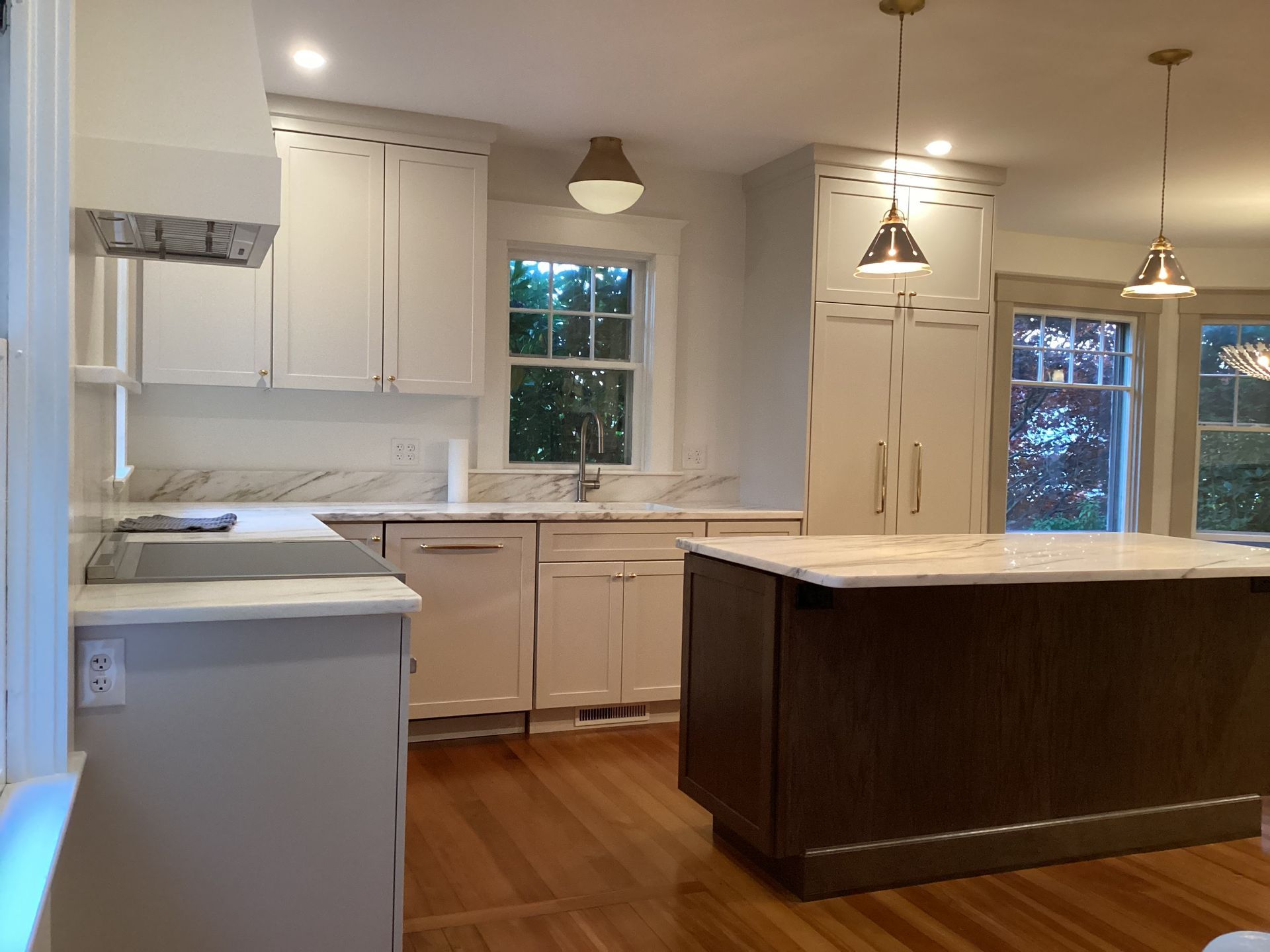 A kitchen with white cabinets and a large island.
