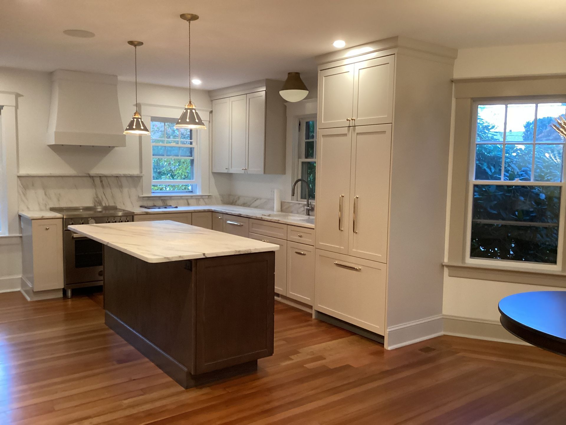 A kitchen with white cabinets and a large island.