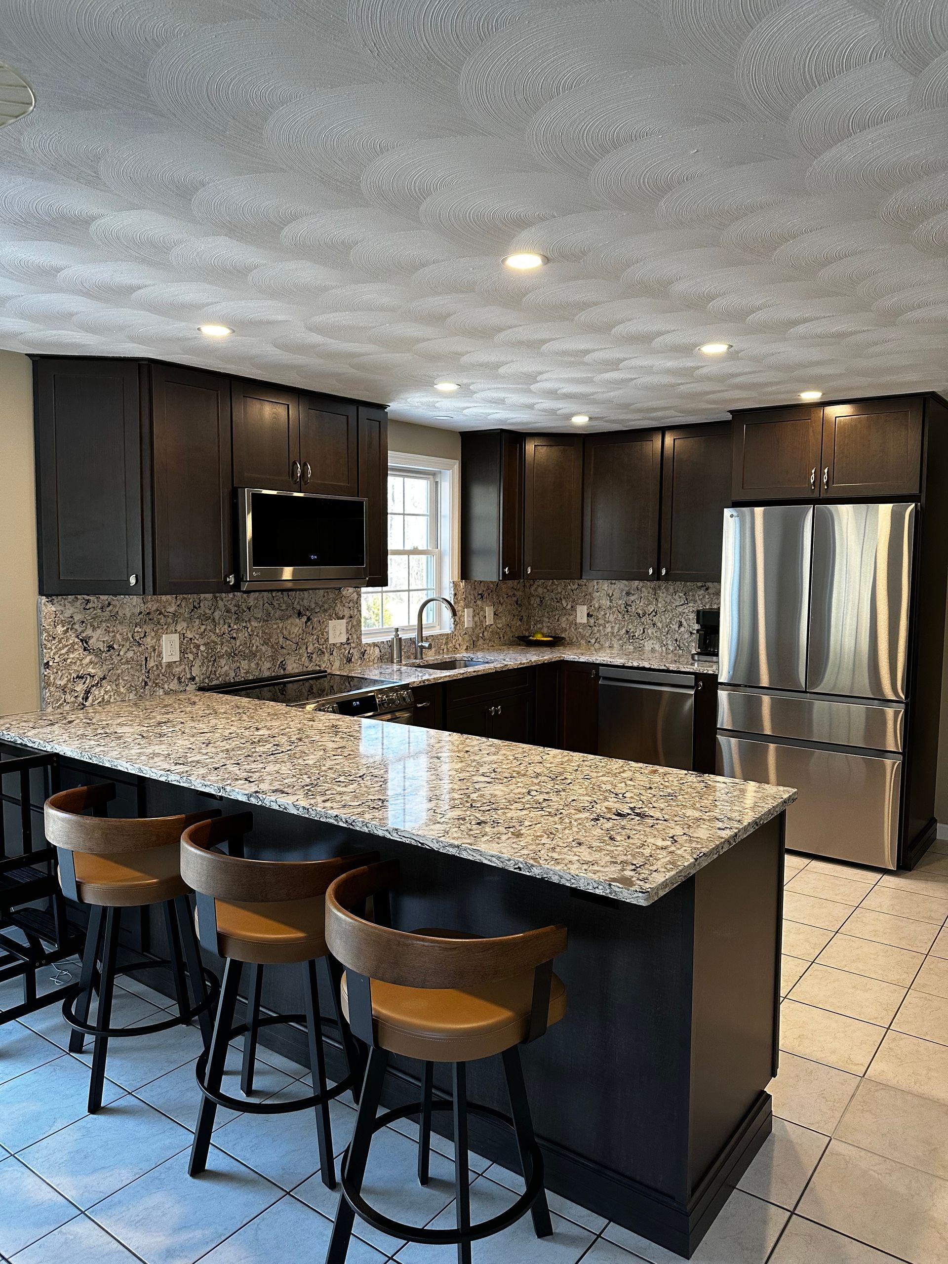 A kitchen with granite countertops and stainless steel appliances.