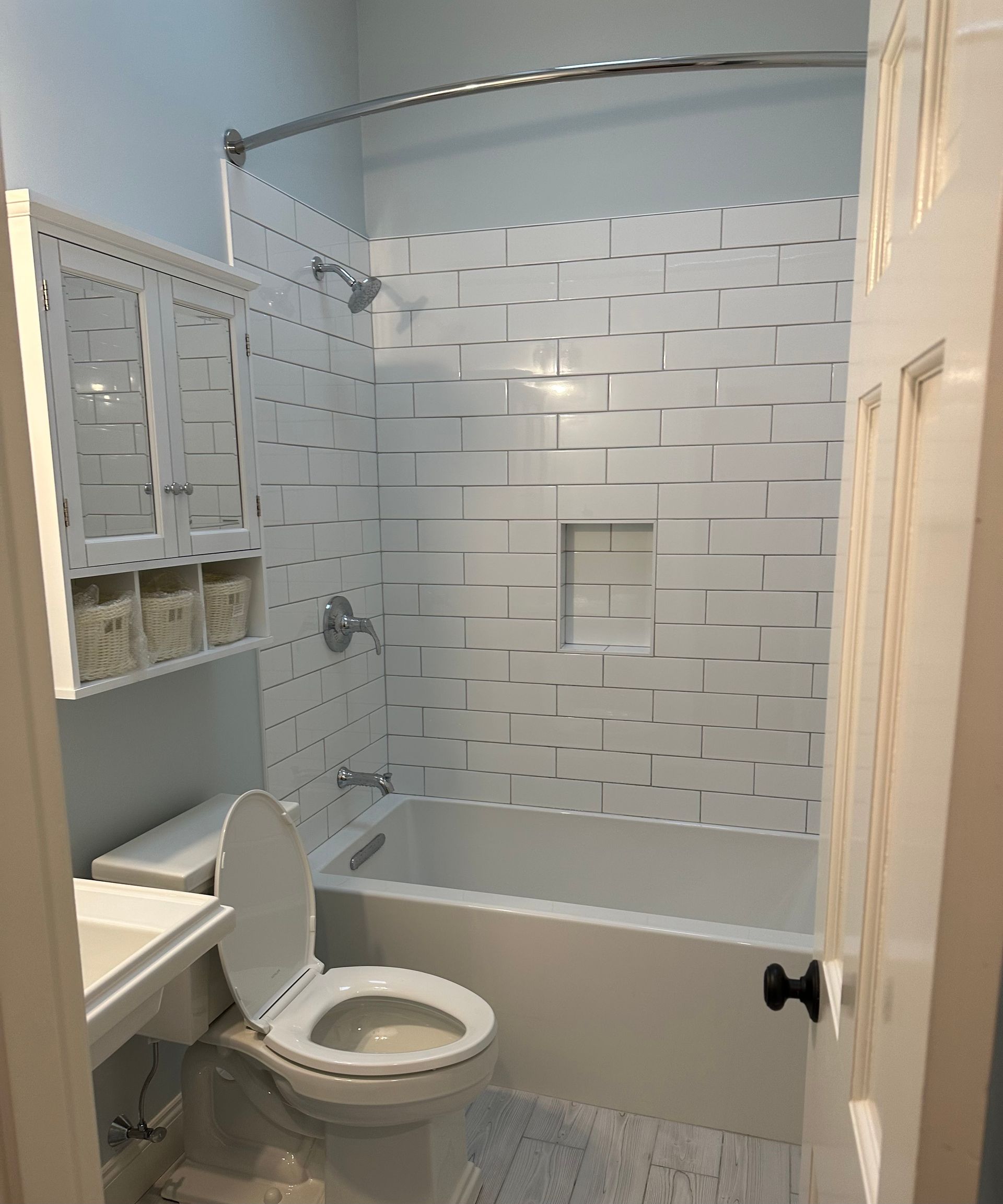 A bathroom with a toilet, sink, tub and shower.