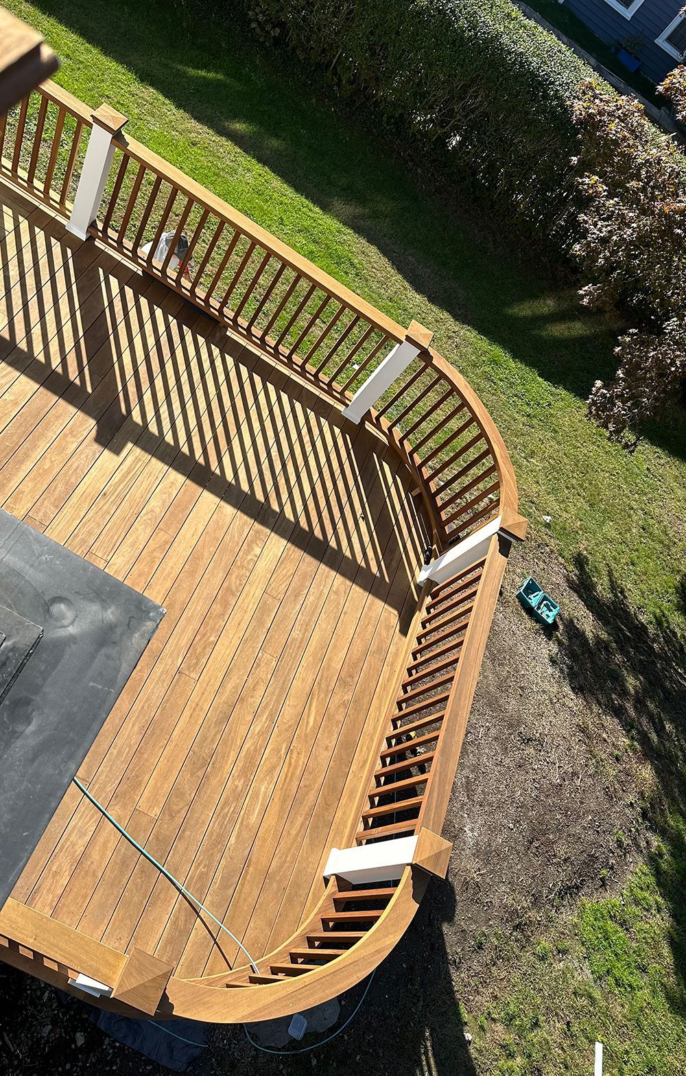 An aerial view of a wooden deck in a backyard.
