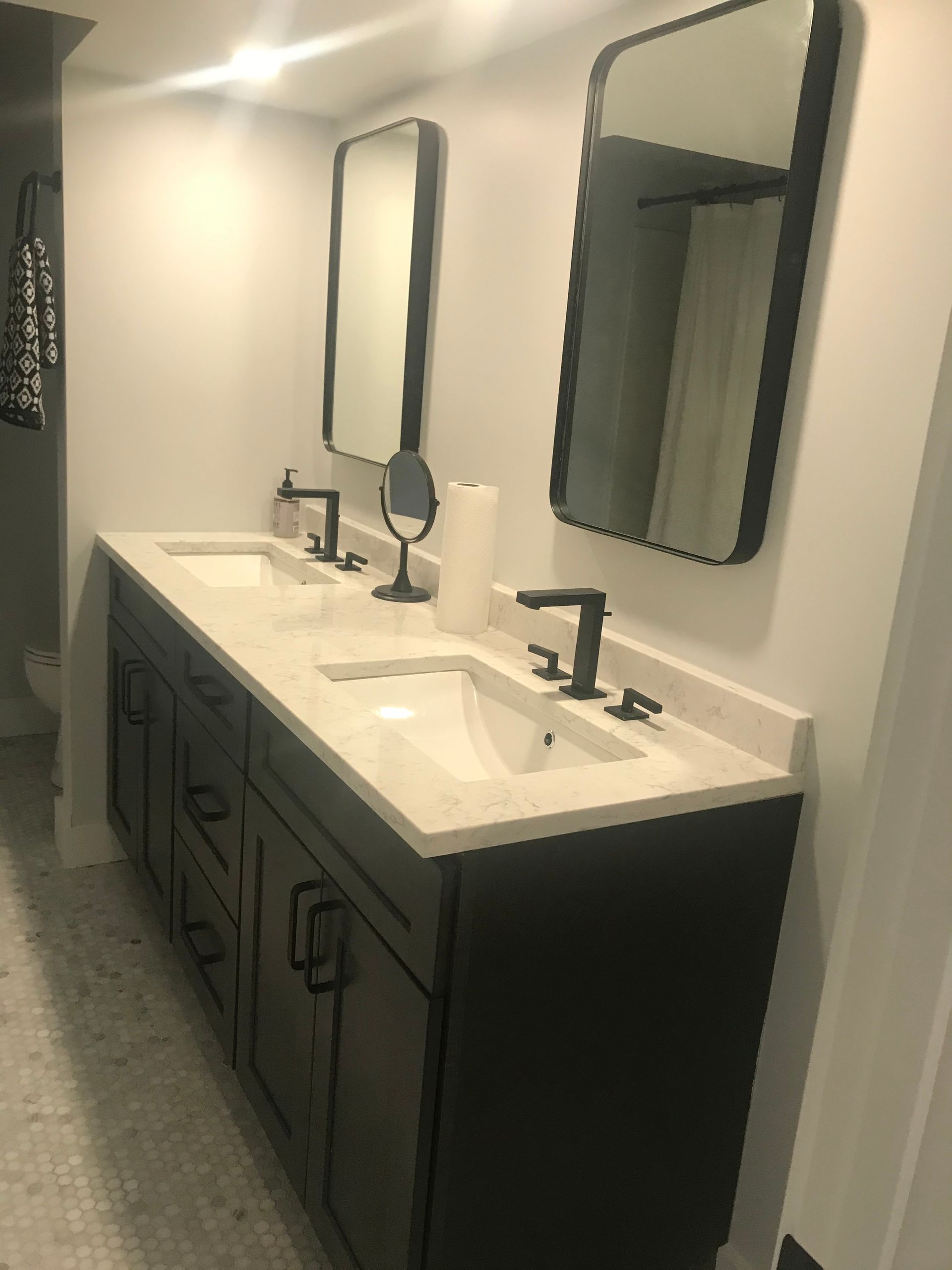 A bathroom with two sinks and two mirrors.