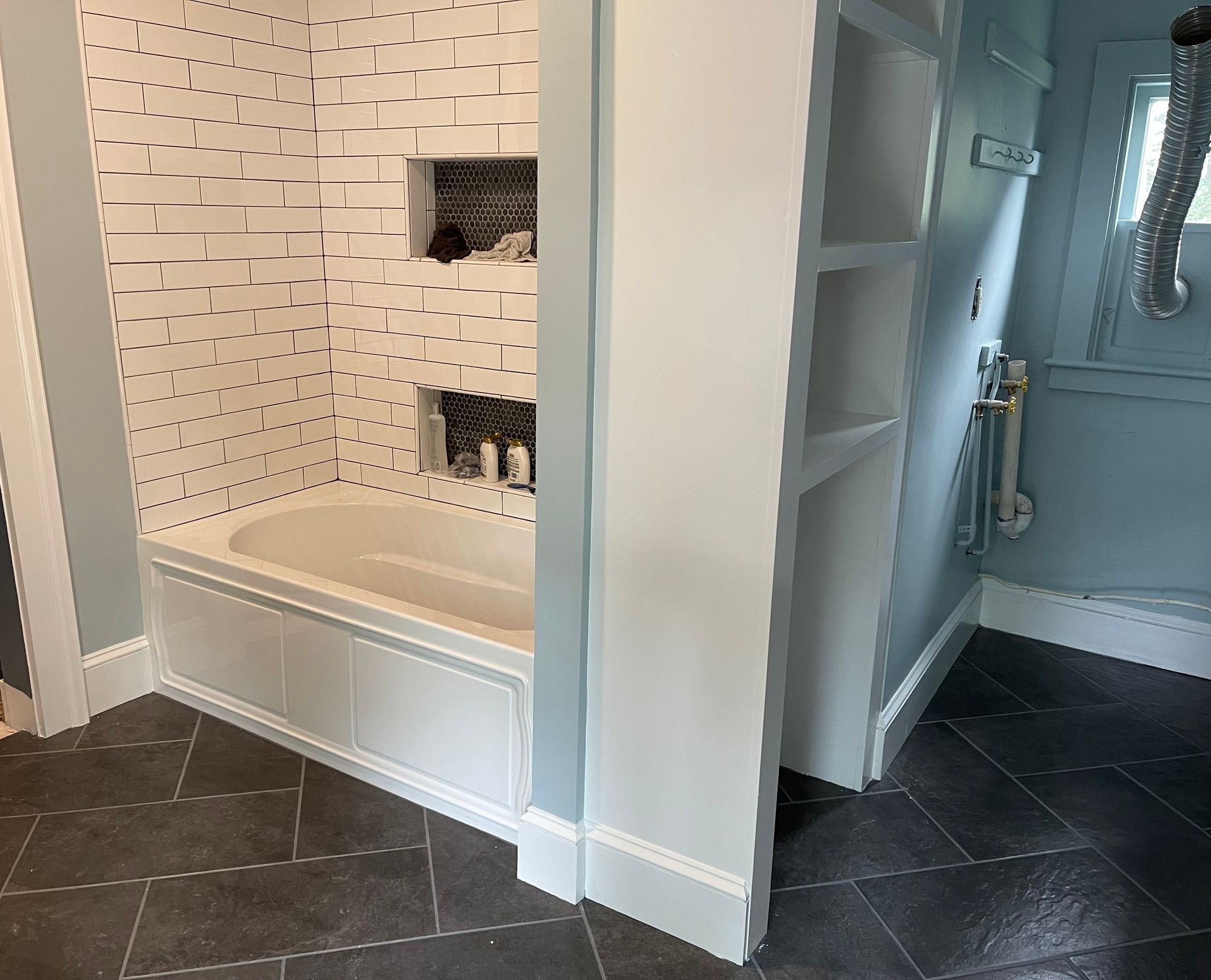 A bathroom with a bathtub and a shower.