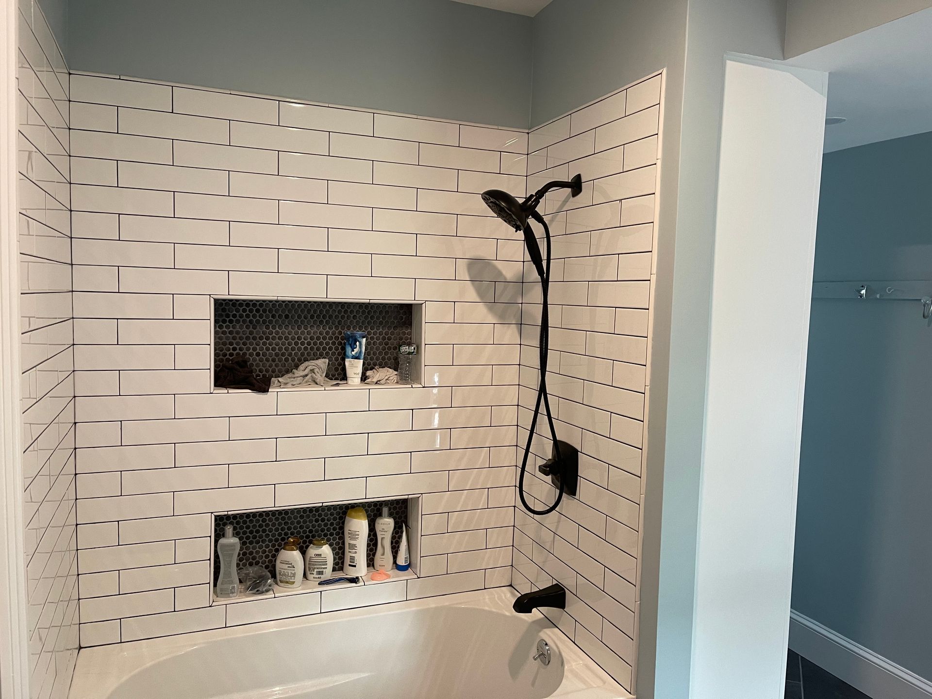 A bathroom with a bathtub and a shower.