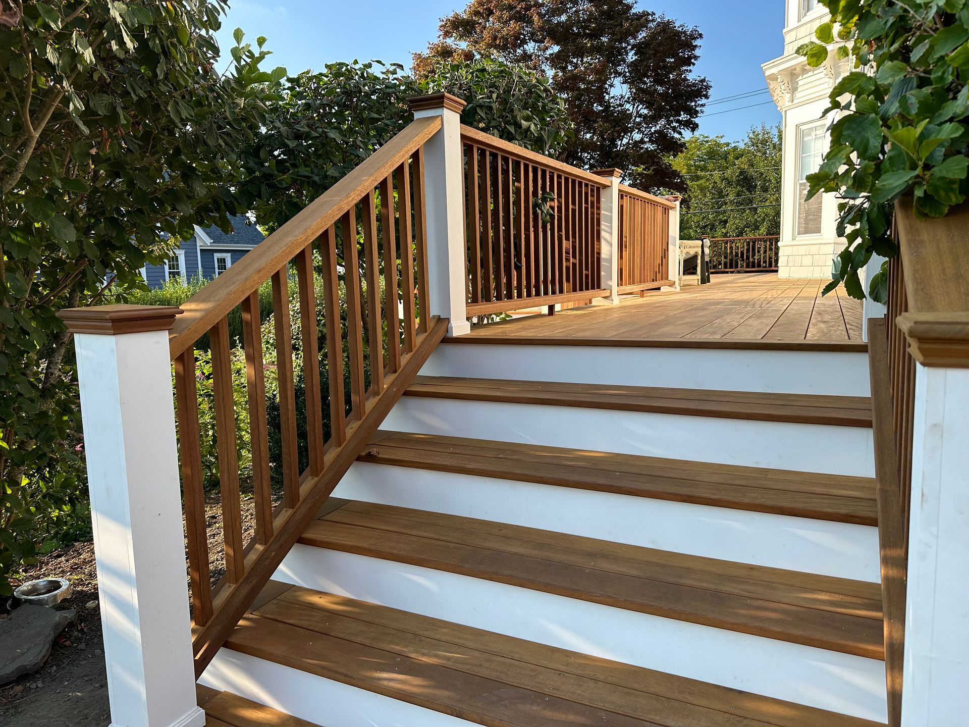 A set of stairs leads up to a deck with a wooden railing.
