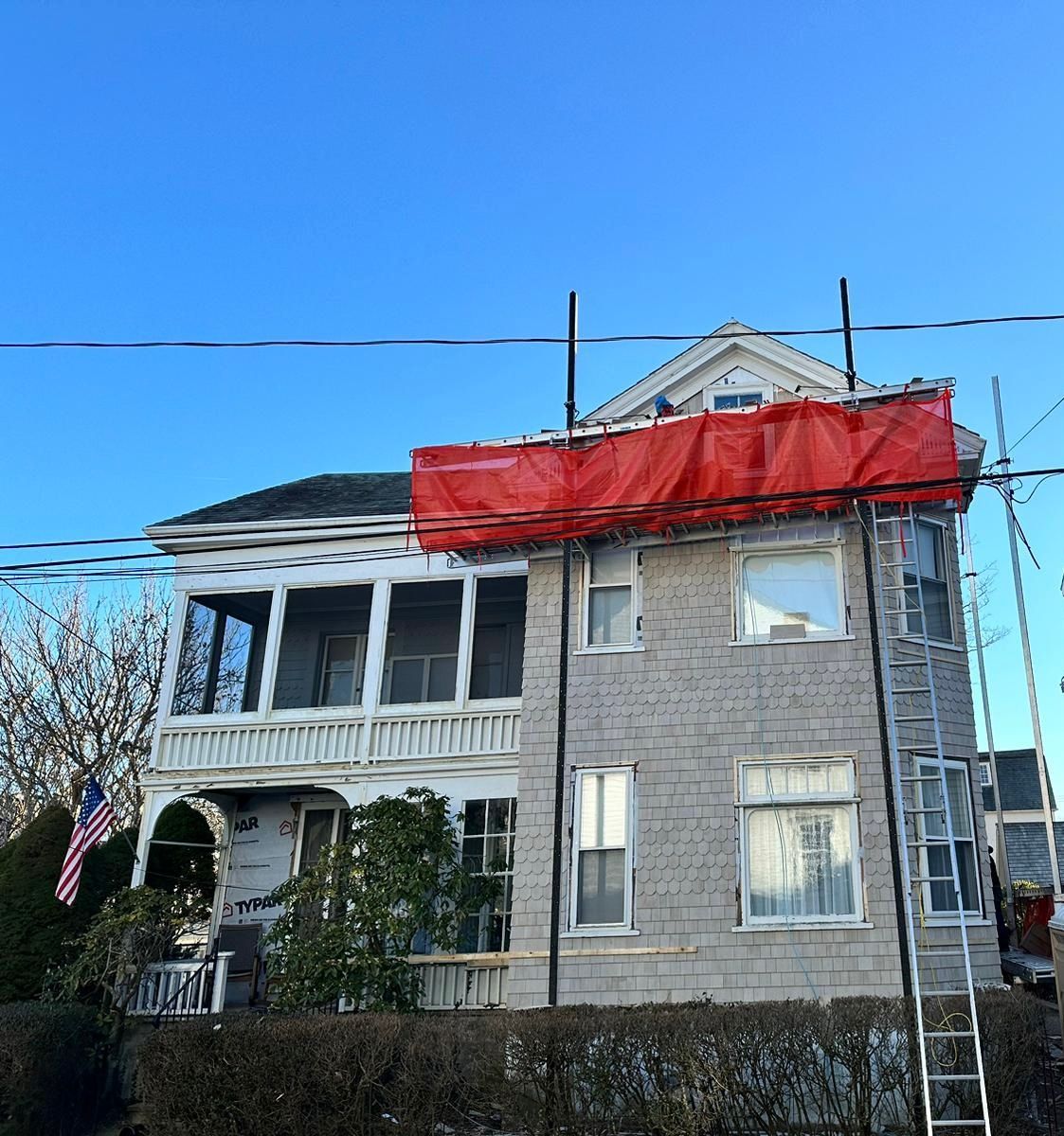 A house with a red tarp on top of it.