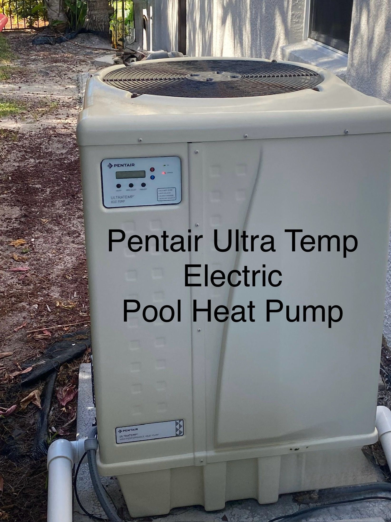 Pentair Ultra Temp Electric Pool Heat Pump; beige unit with fan on top, control panel, and PVC pipes.