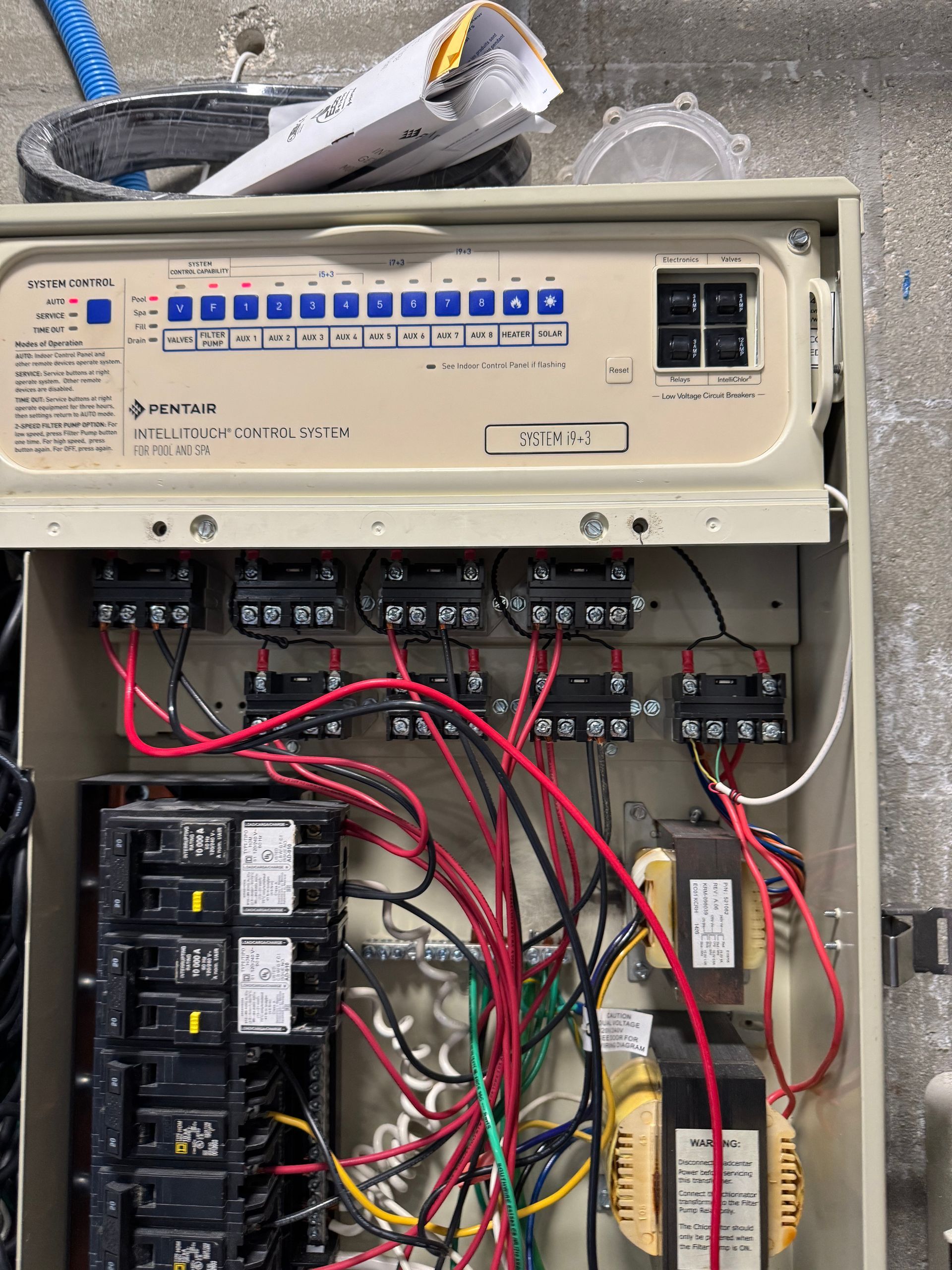 Electrical control panel with switches, wiring, and circuit breakers.