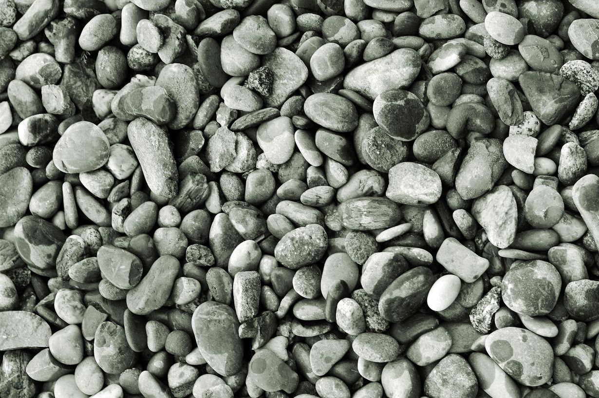 Close-up of a pile of gray, smooth river stones.
