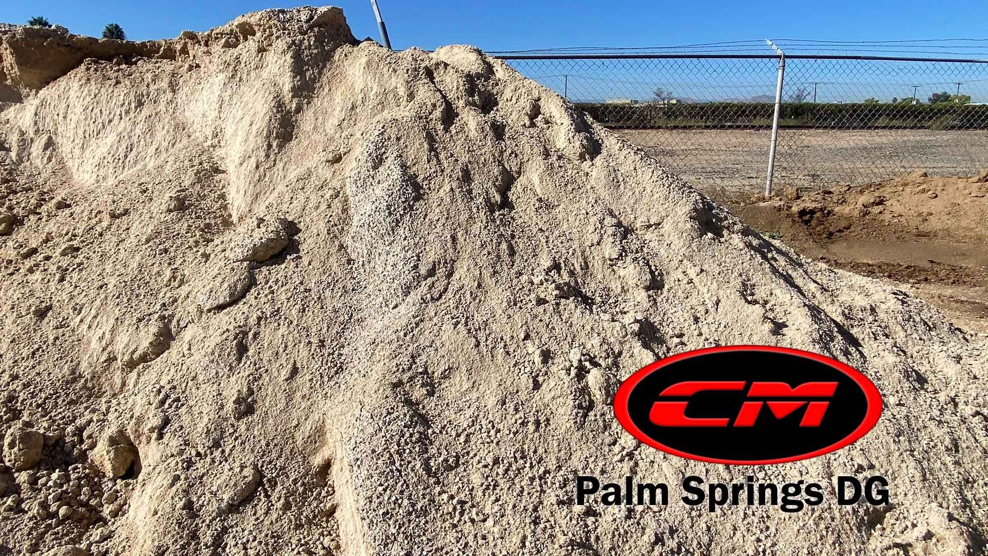 Pile of tan DG (decomposed granite) with CM Palm Springs logo.