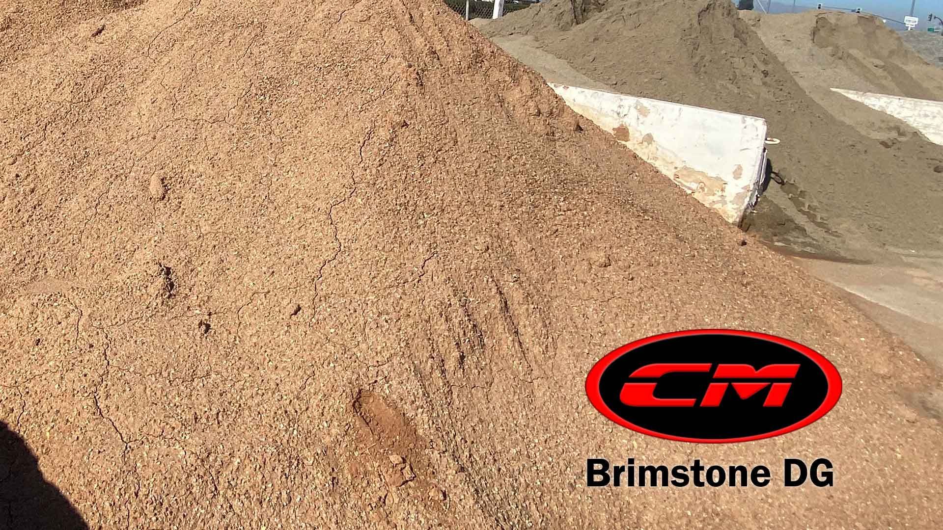 Pile of light brown Brimstone DG aggregate in a commercial yard with other piles.