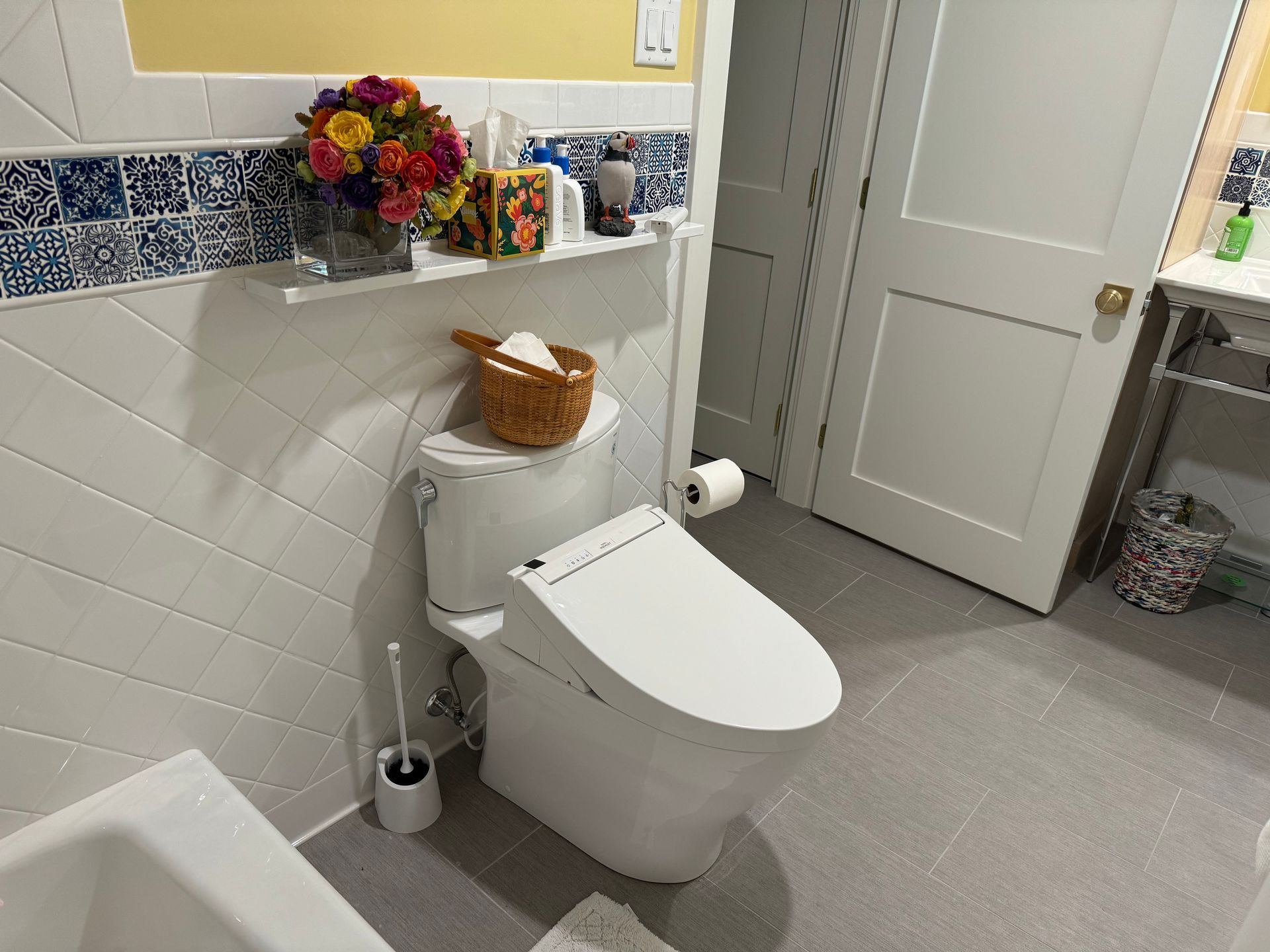 A bathroom with a toilet , sink , and bathtub.