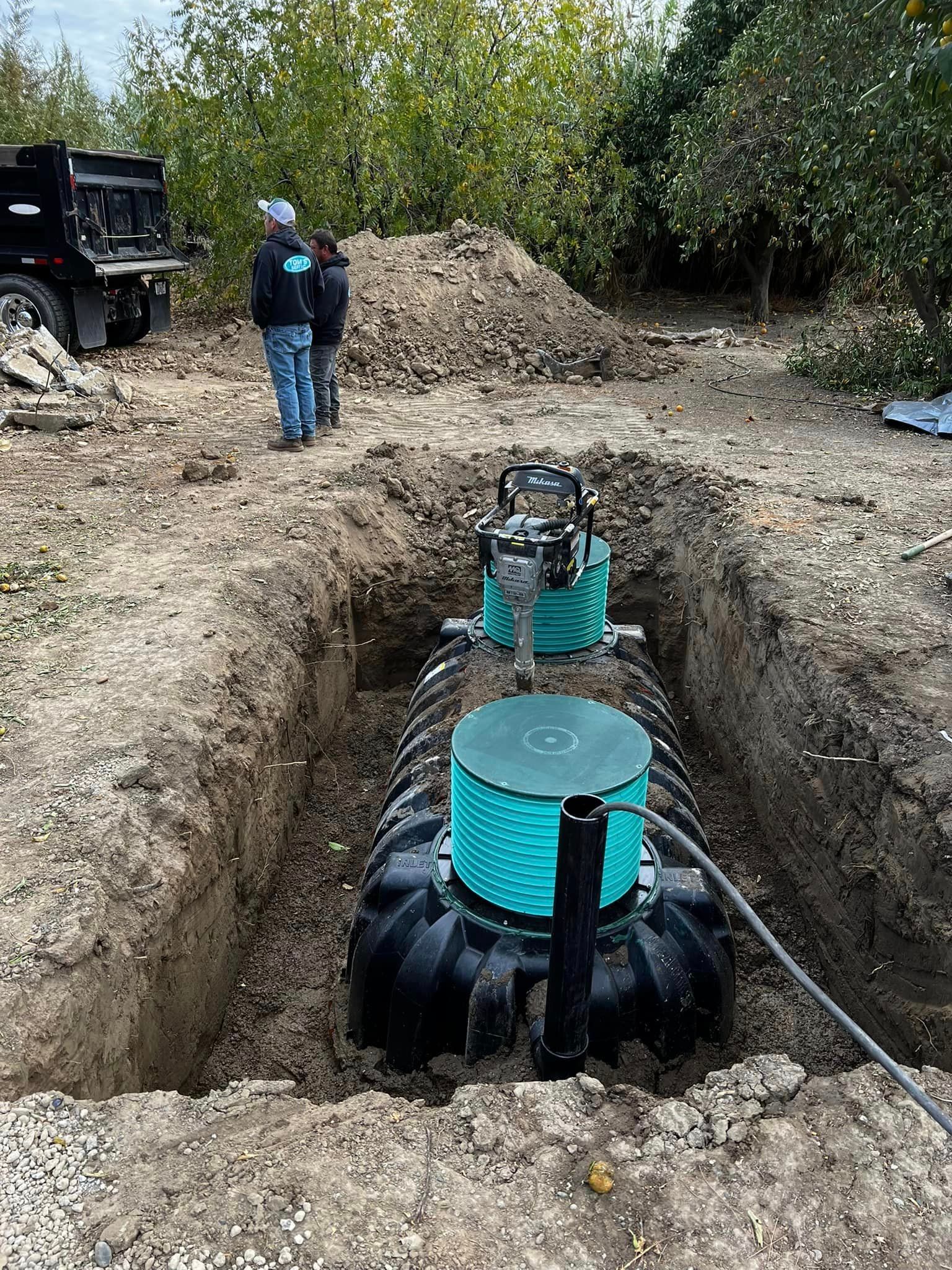 A septic tank is being installed in a hole in the ground.