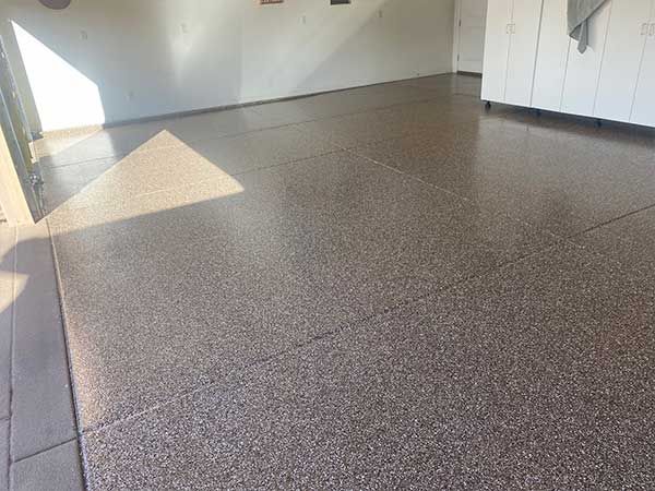 Garage with a speckled epoxy floor.