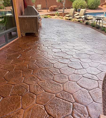 Brown patterned concrete patio with outdoor kitchen.