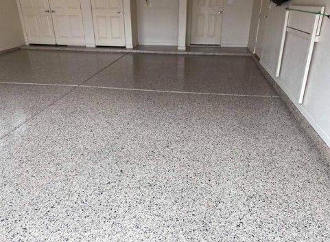 Garage with speckled epoxy flooring.