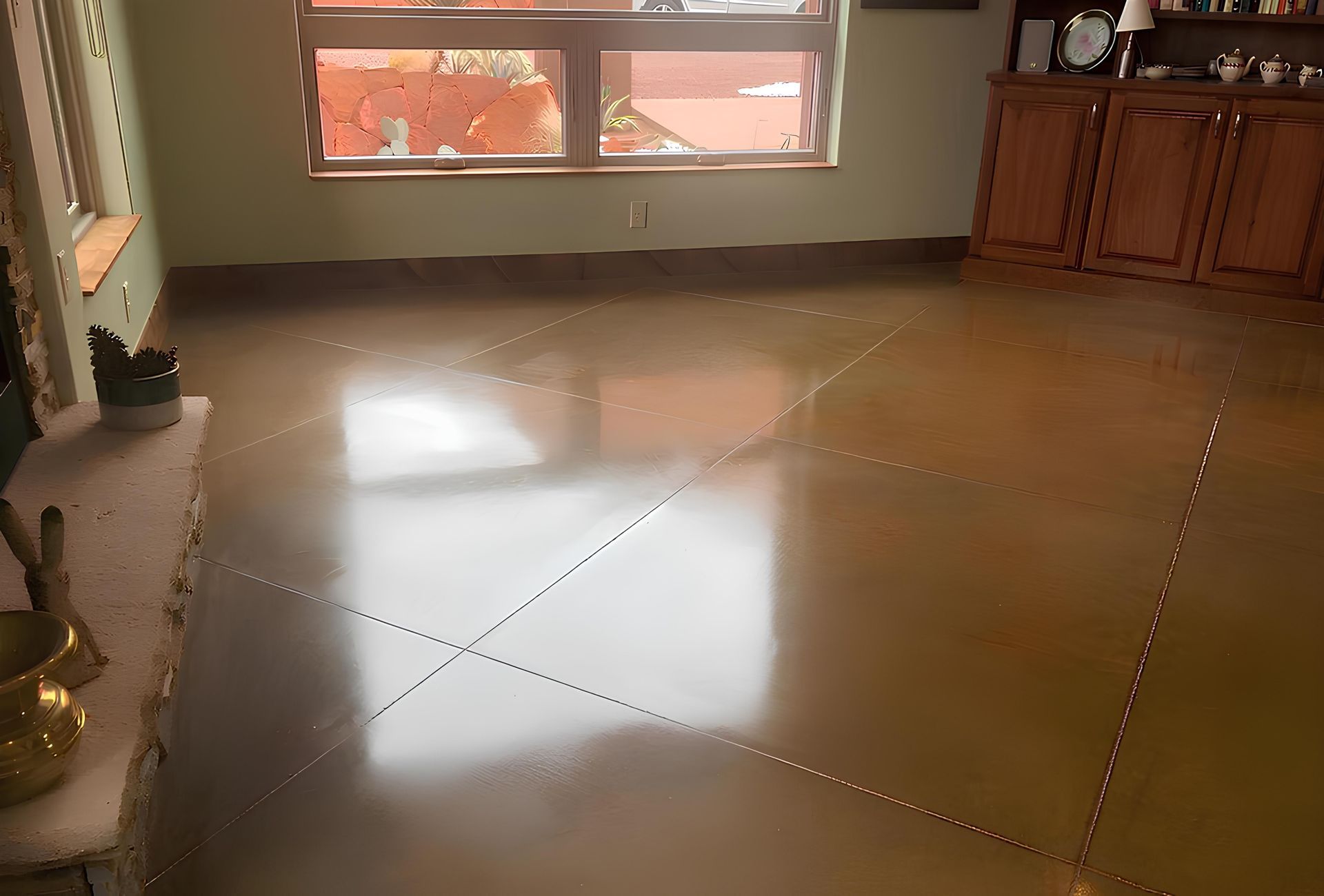 Polished concrete floor in a room with a window, brown cabinets, and fireplace.