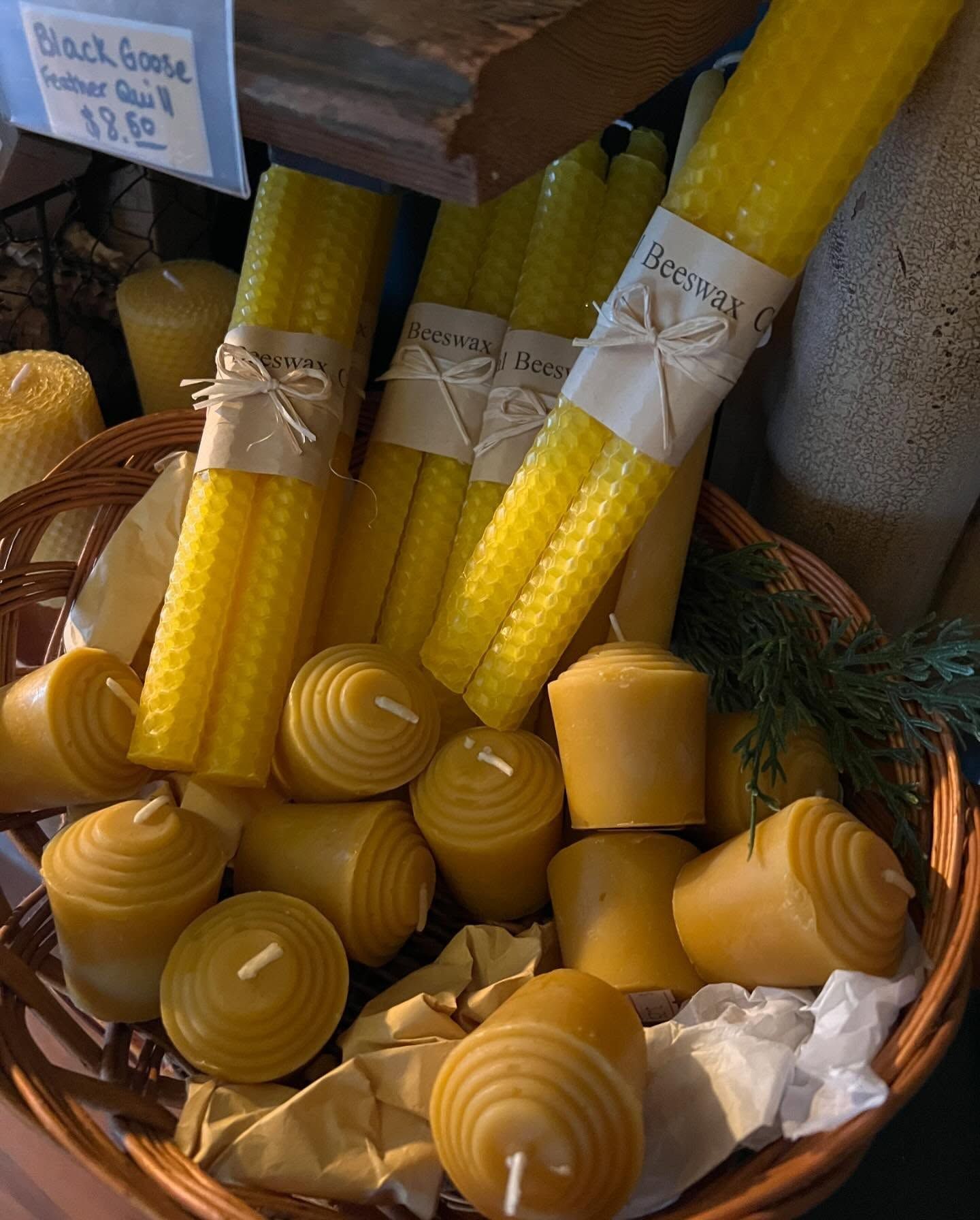 A bunch of yellow candles are in a basket