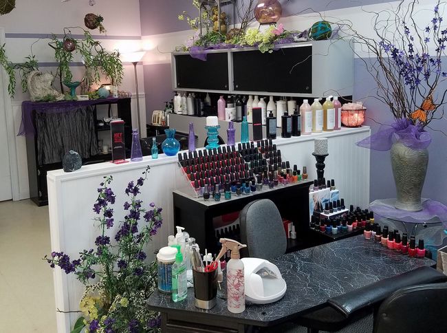 A display of nail polish is on a table in a salon