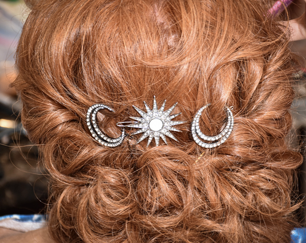 A close up of a woman 's hair with a hair clip in it.