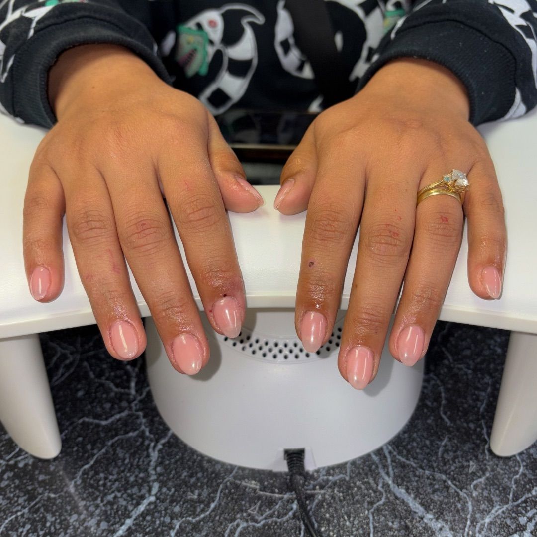 A woman's hands with a natural manicure design.