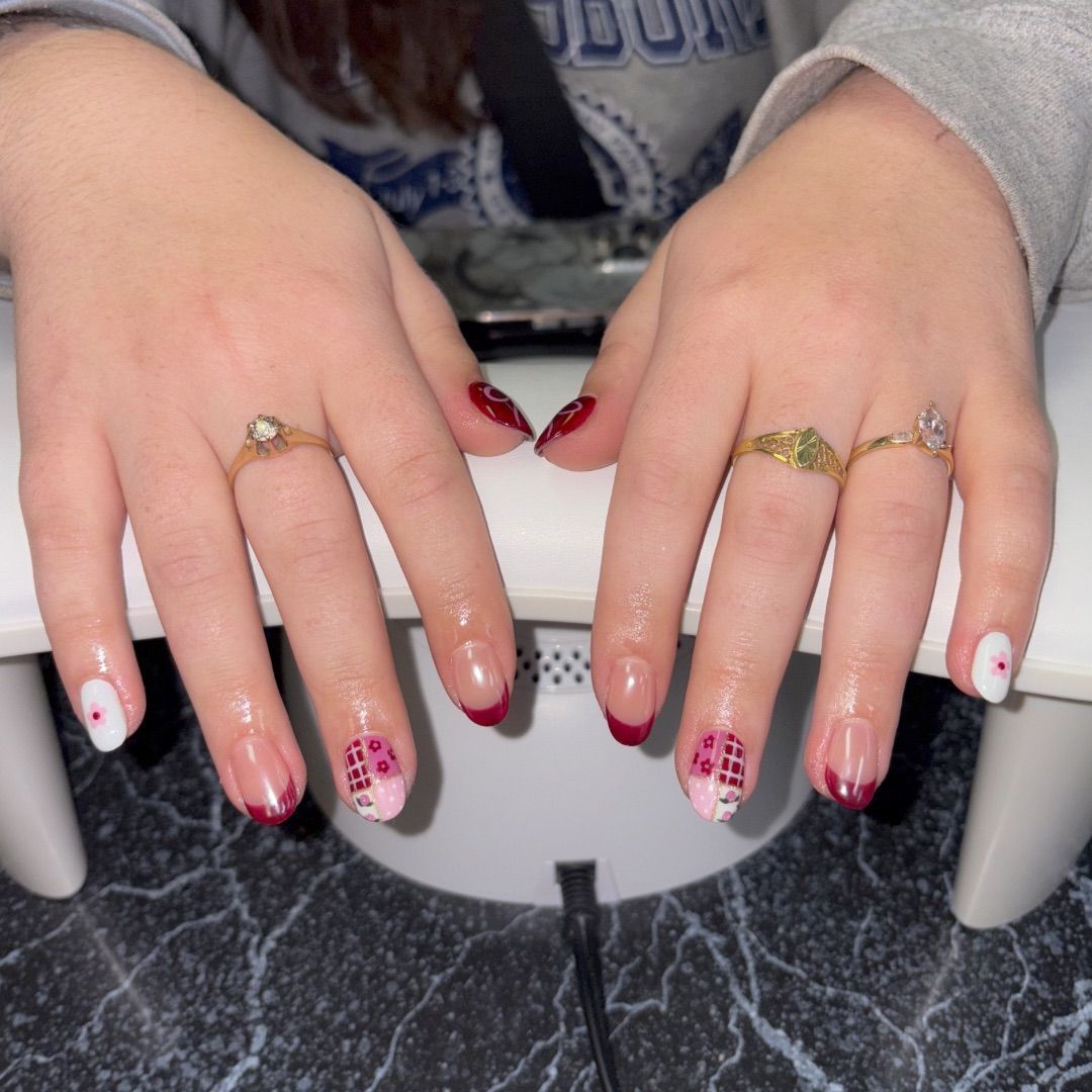 A woman's hands with a red stamp design.