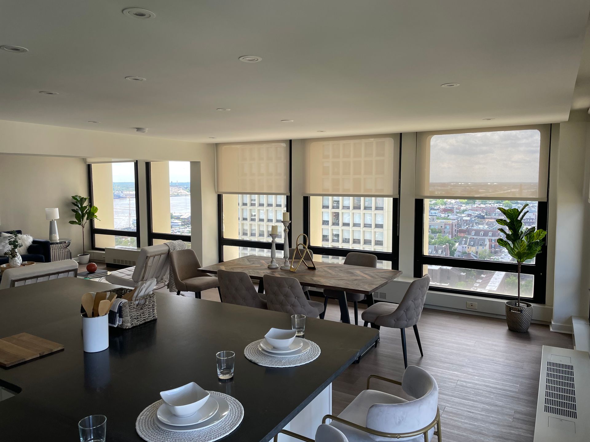 A large dining room with a table and chairs and lots of windows.