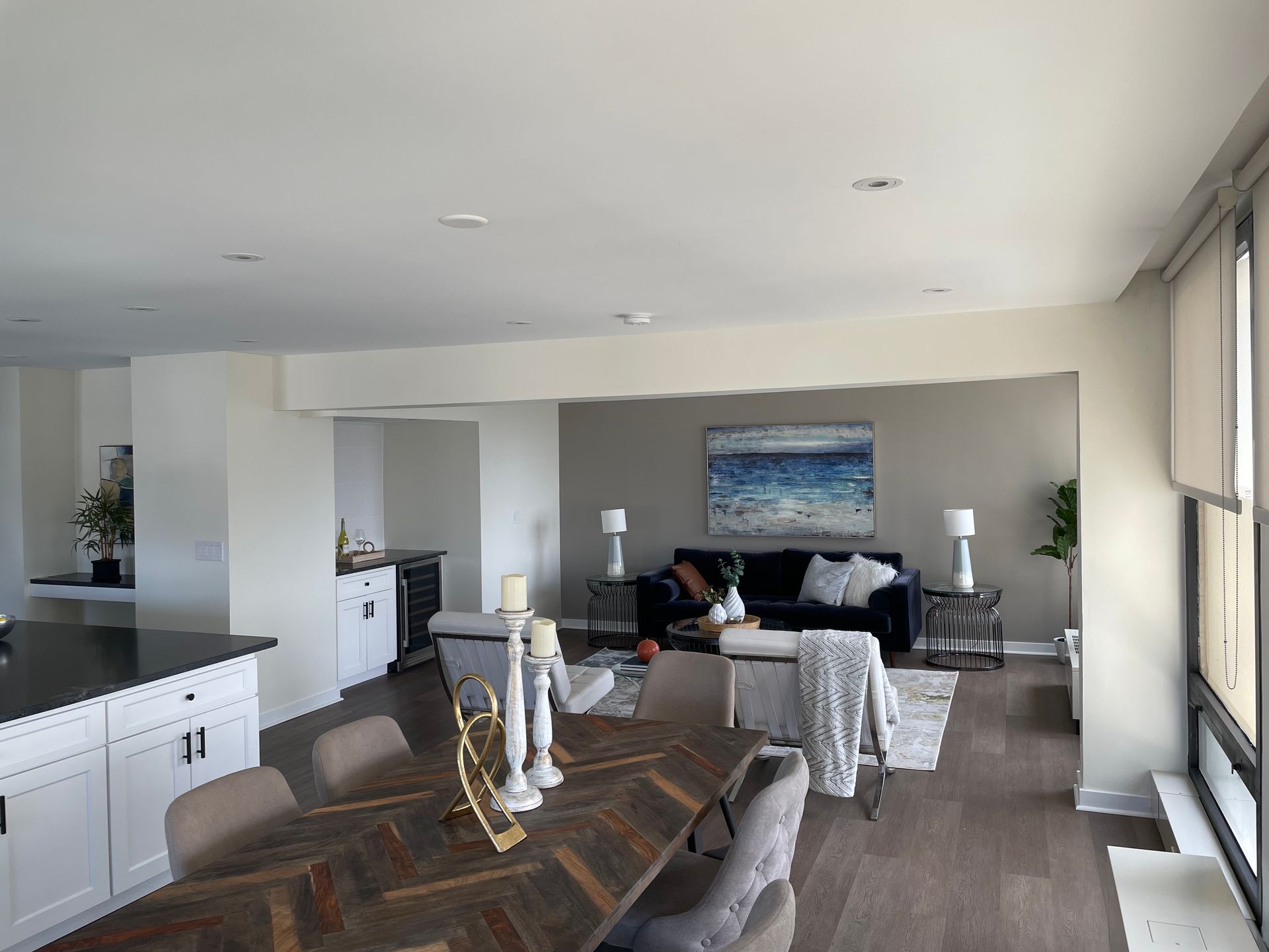 A living room with a dining table and chairs and a couch