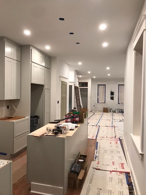 A kitchen under construction with a large island in the middle of the room.