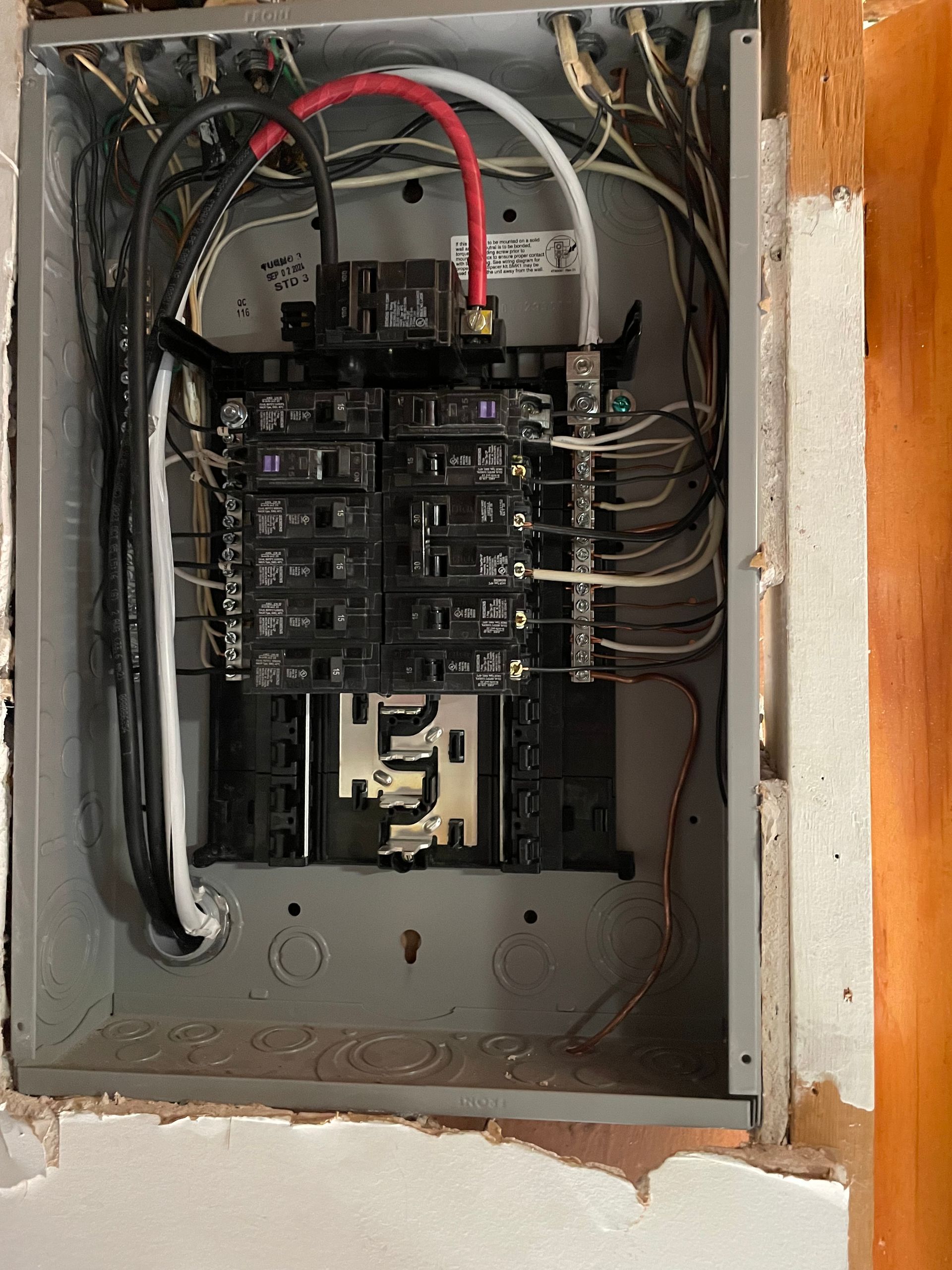 A close up of a electrical box with wires coming out of it.