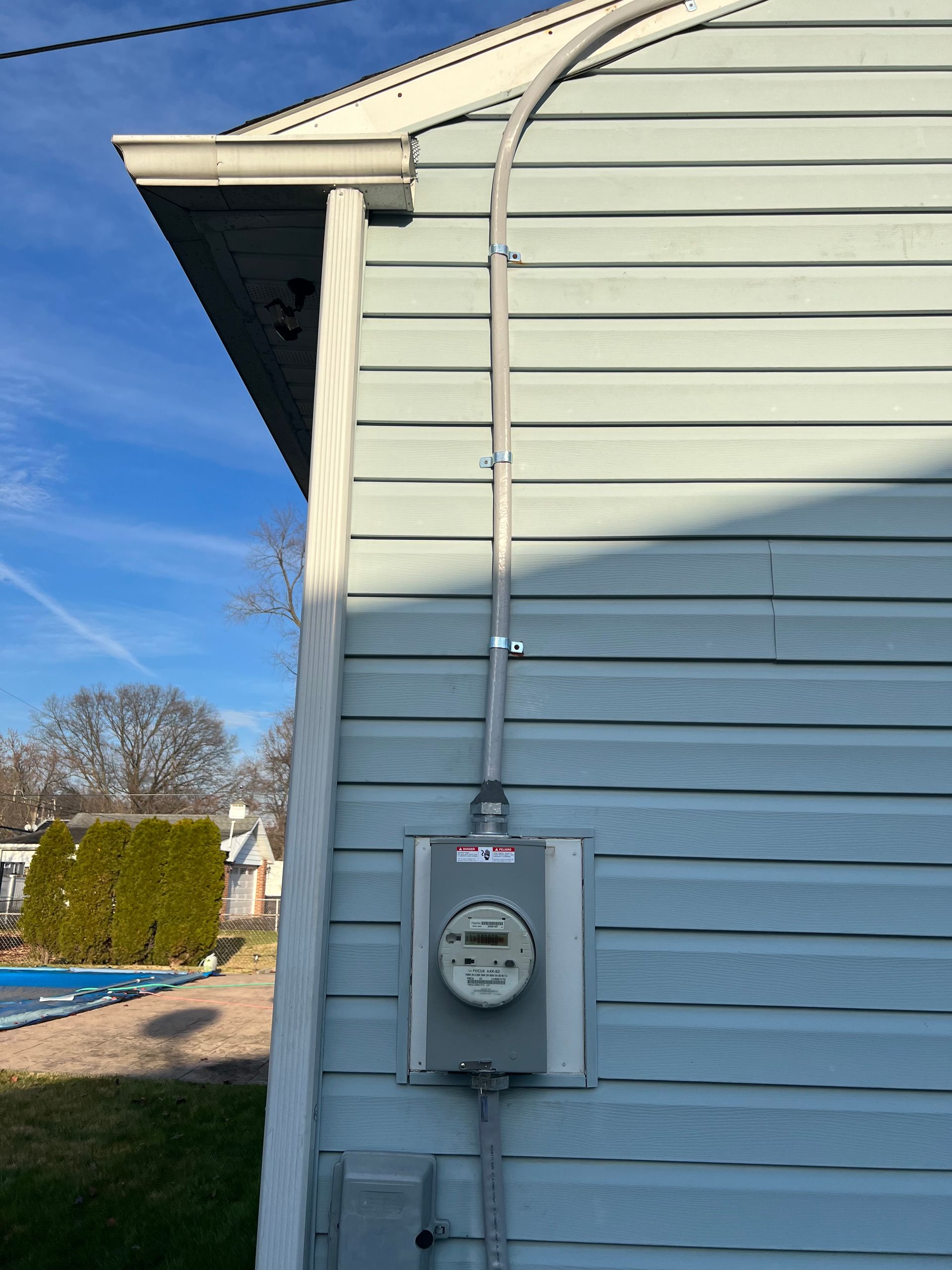 A house with a meter on the side of it.