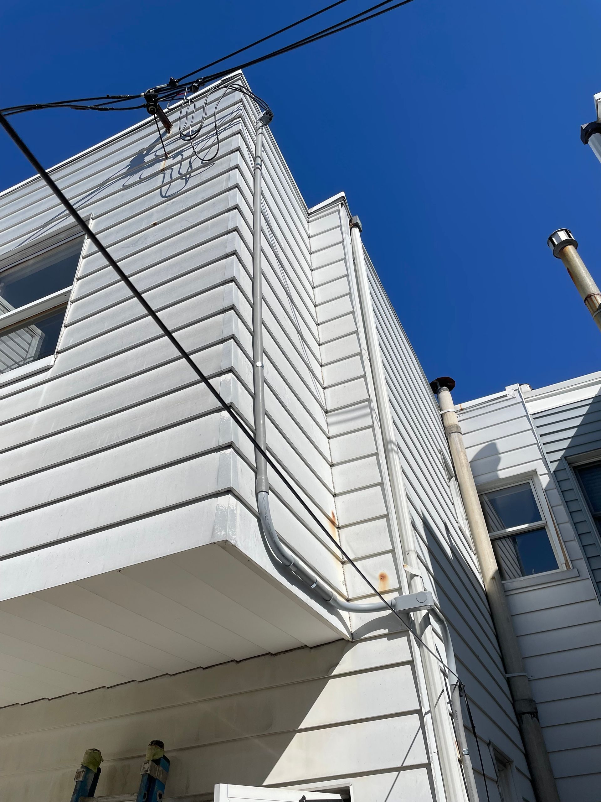 A white building with a blue sky in the background