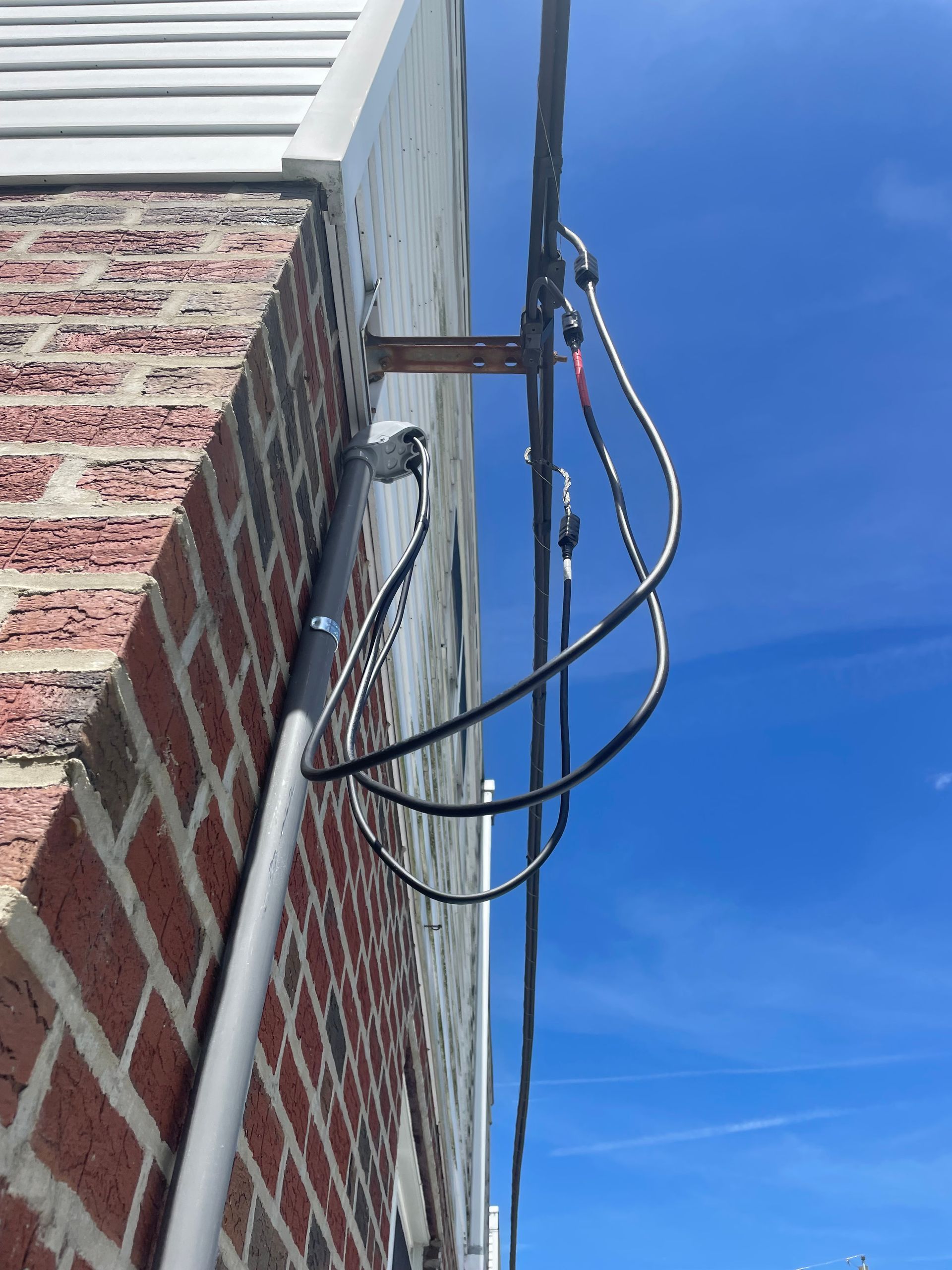 A brick building with a bunch of wires attached to it