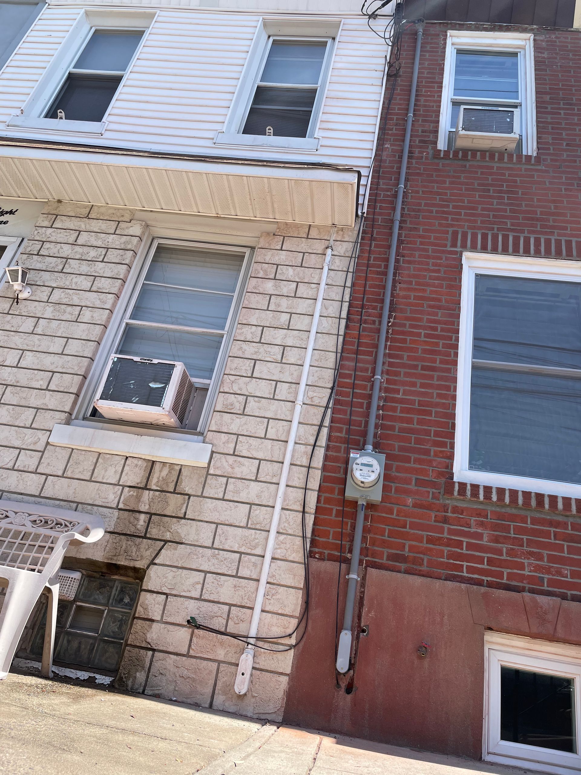 A brick building with a white building next to it