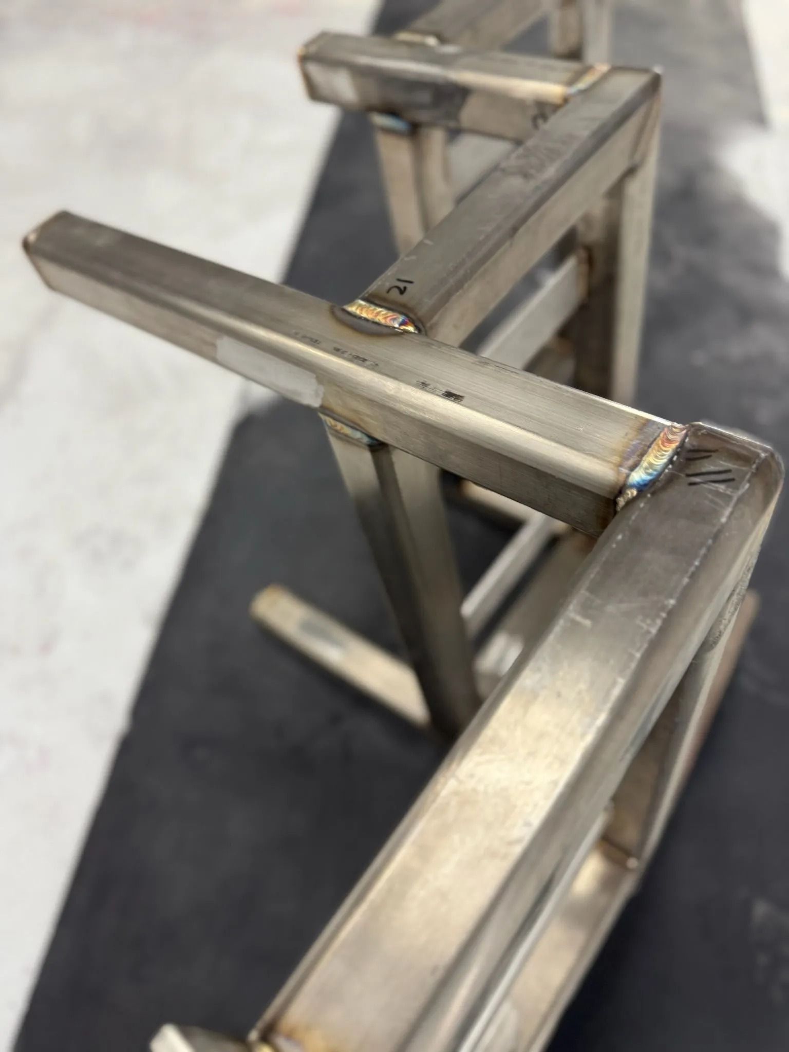 Welded steel frame, partially constructed with visible welds.