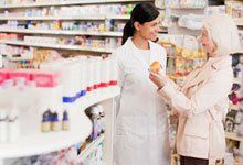 Pharmacist assisting the old lady